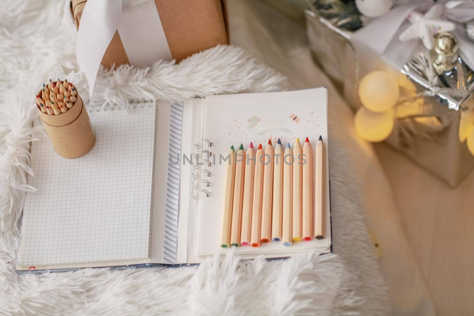 Christmas pencils on a Notepad near the Christmas tree by ElenaBatkova