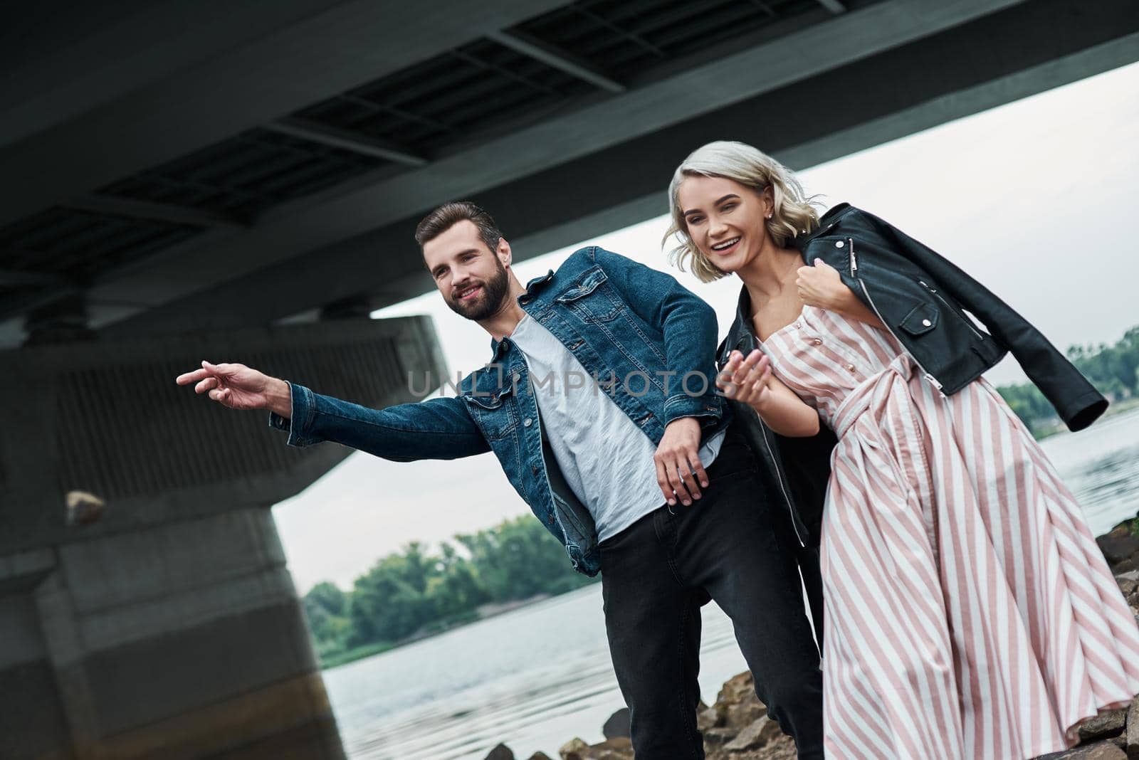 Romantic date outdoors. Young couple dancing on the city street smiling playful by friendsstock