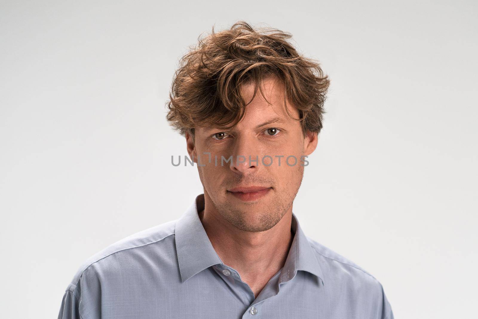 Nice-looking attractive guy isolated on light white pastel background. Closeup photo of amazing friendly guy perfect neat appearance hairstyle. Studio portrait by LipikStockMedia