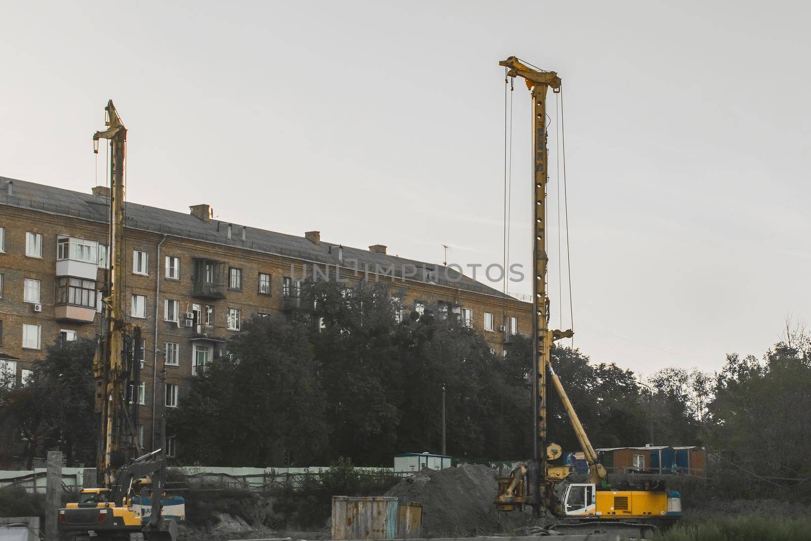 Heavy industrial equipment for drilling pits and wells on the construction site.