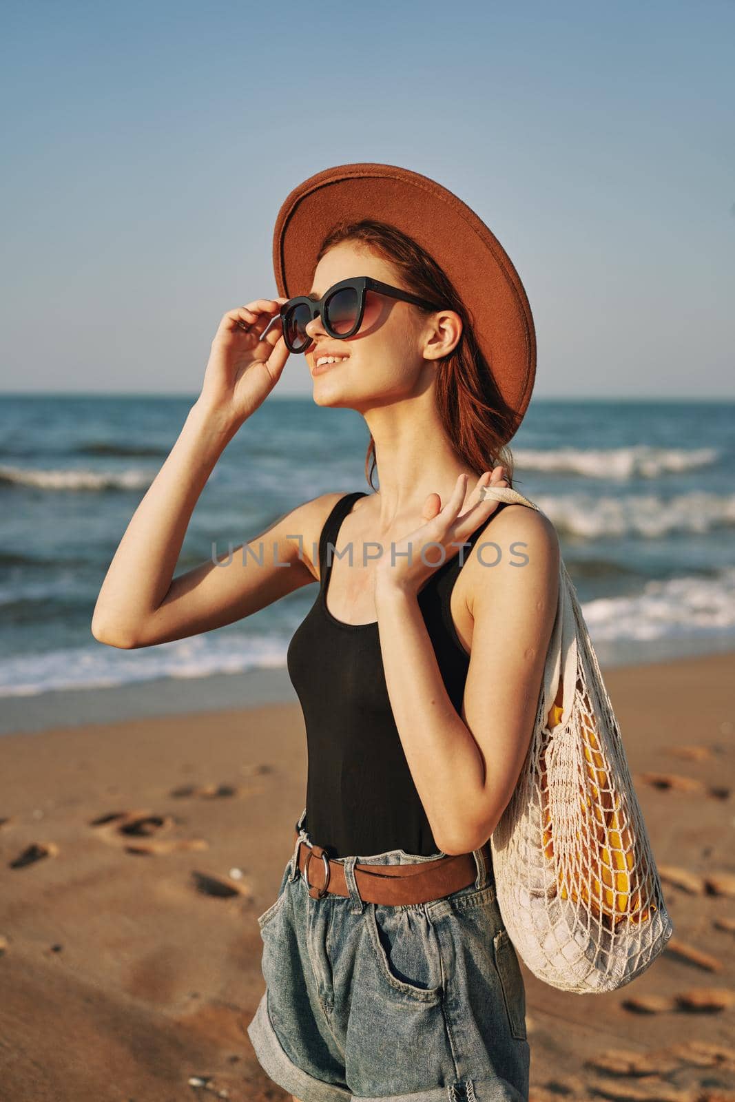 woman walking on the beach landscape sun fun lifestyle. High quality photo