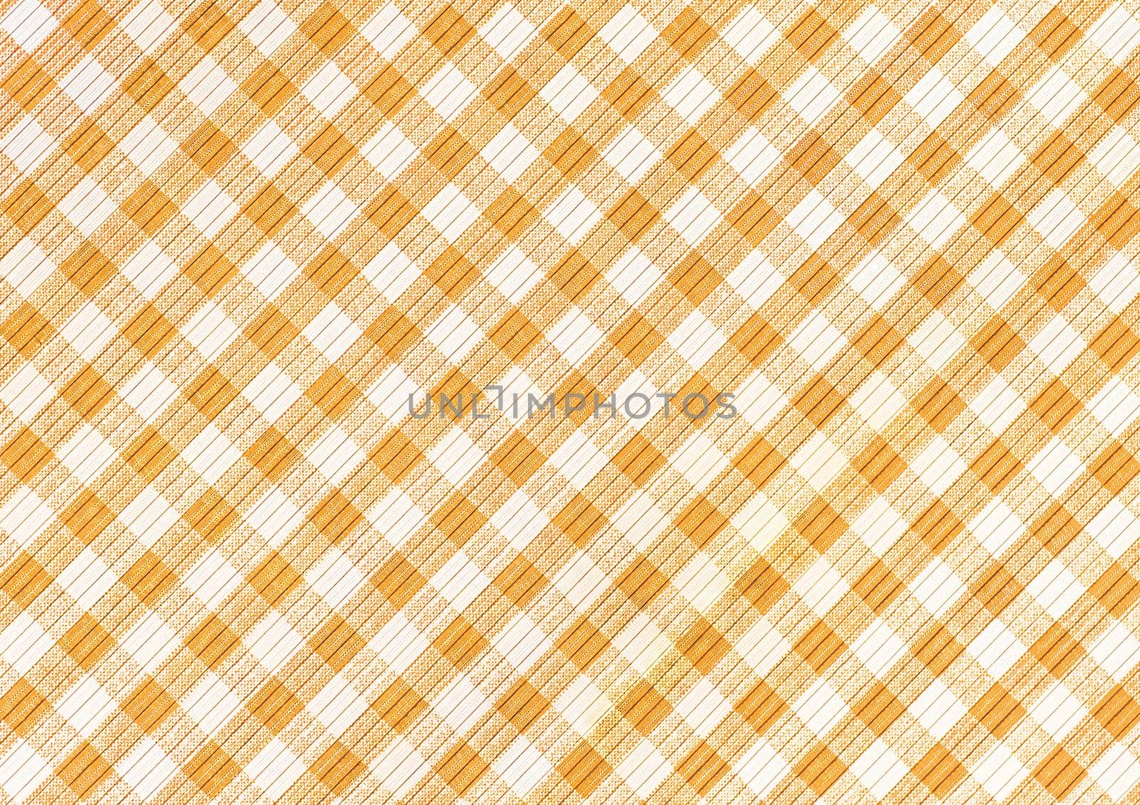 Orange and white abstract checkered pattern background, picnic gingham tablecloth, square fabric texture.