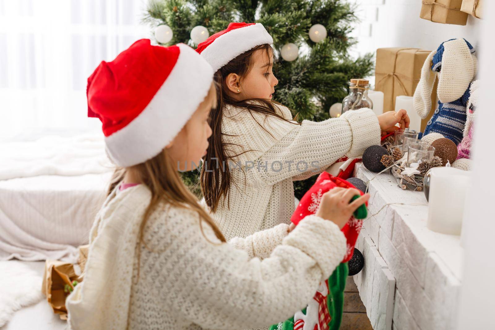 Two little girls in Christmas background.