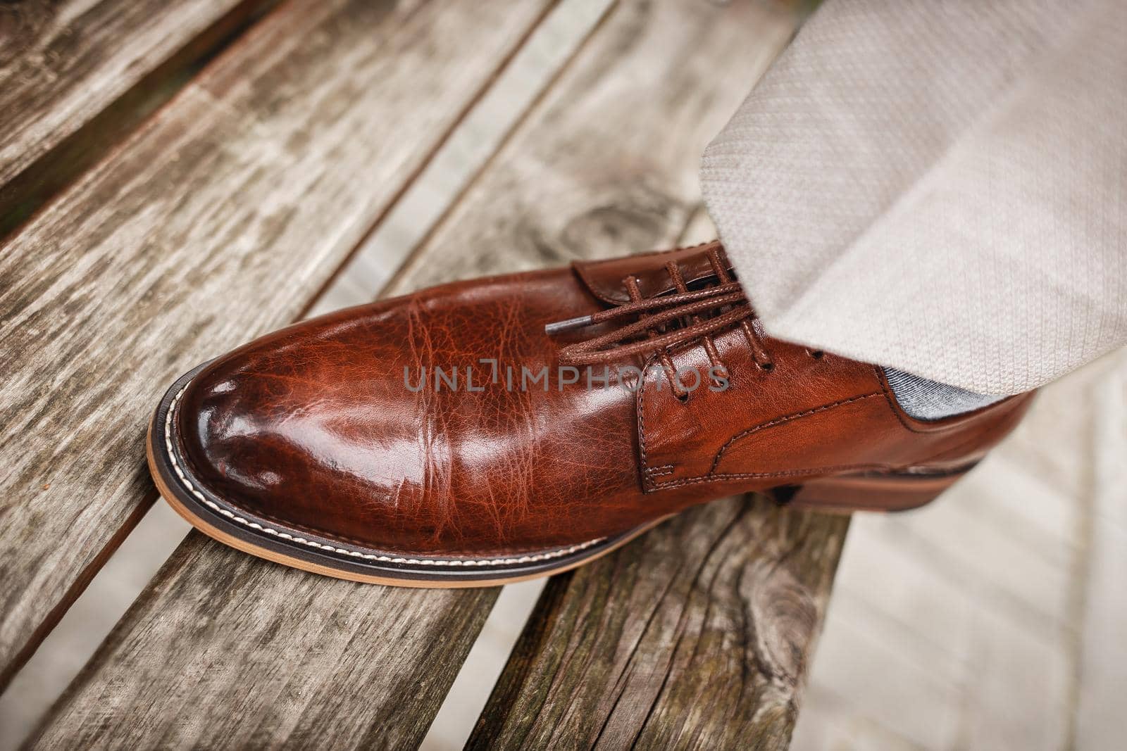 Men's brown shoes made of genuine glossy leather.