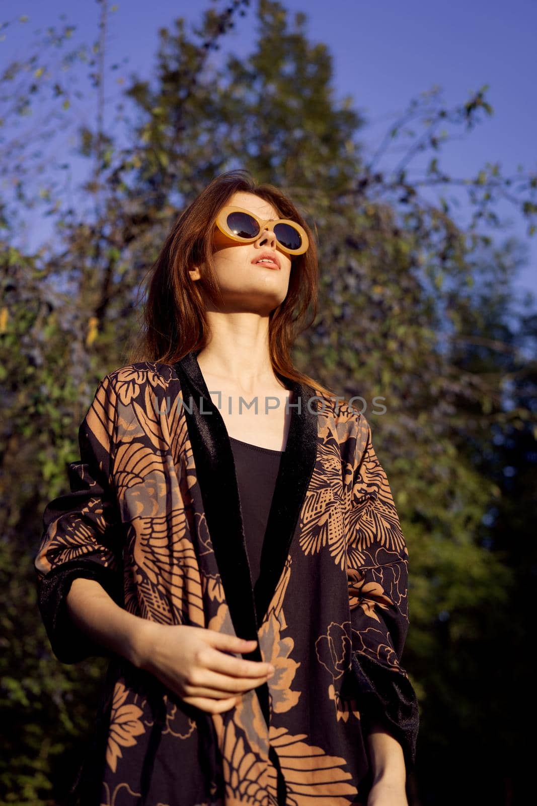 pretty woman wearing sunglasses outdoors fashion nature. High quality photo