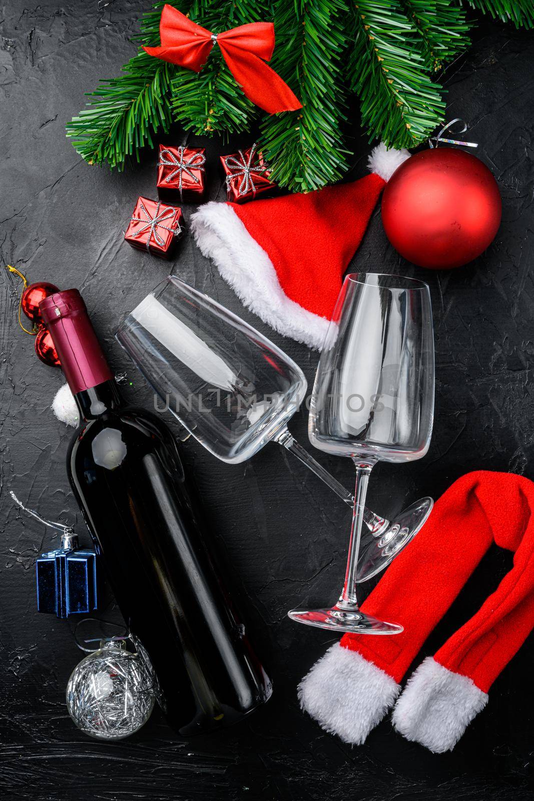 Bottles of wine Merry Christmas and a Happy New Year set, on black dark stone table background, top view flat lay