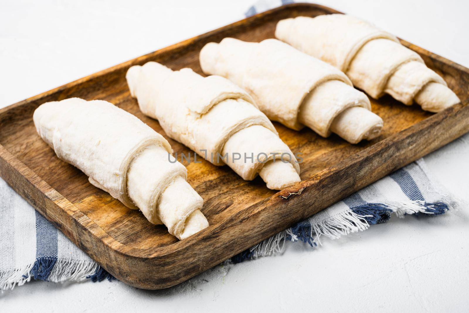 Raw fresh croissants set, on white stone table background