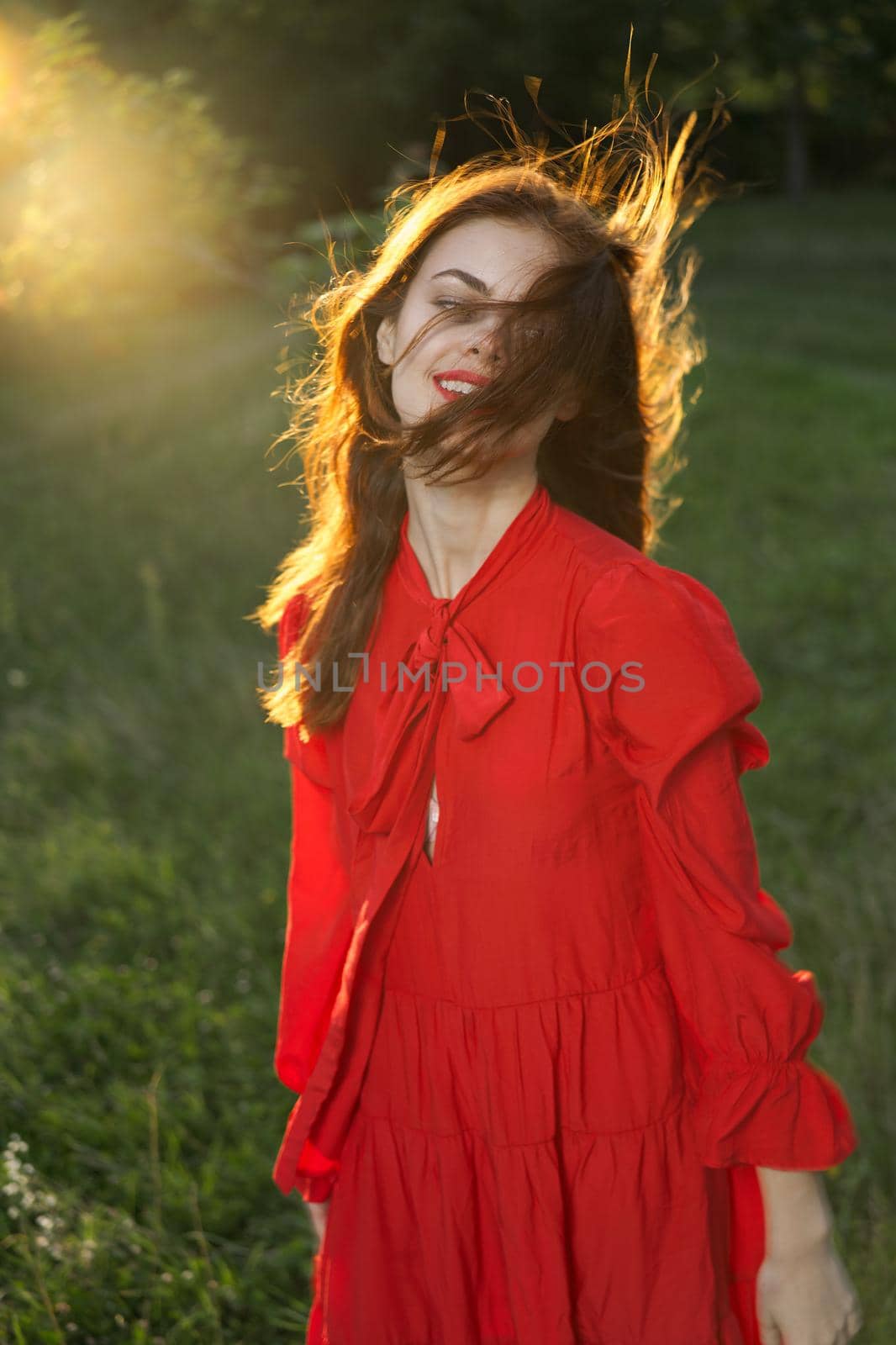 woman in red dress posing nature sun fun. High quality photo