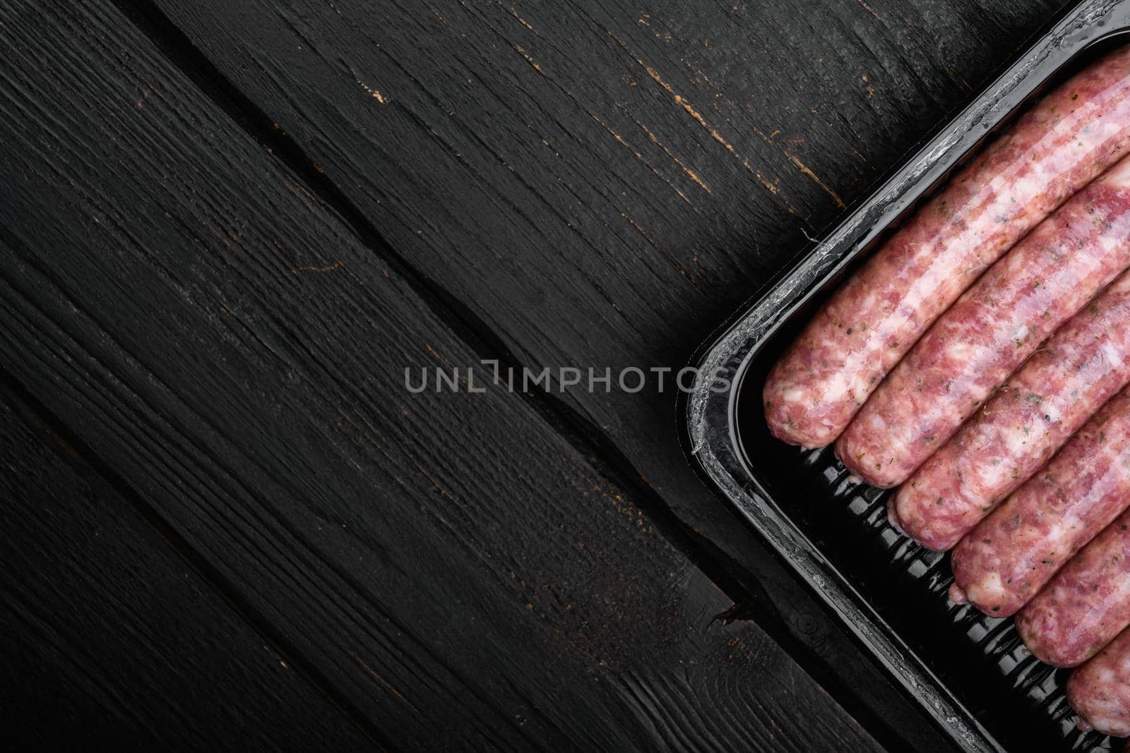 Fresh Polish Sausages pack set, on black wooden table background, top view flat lay, with copy space for text