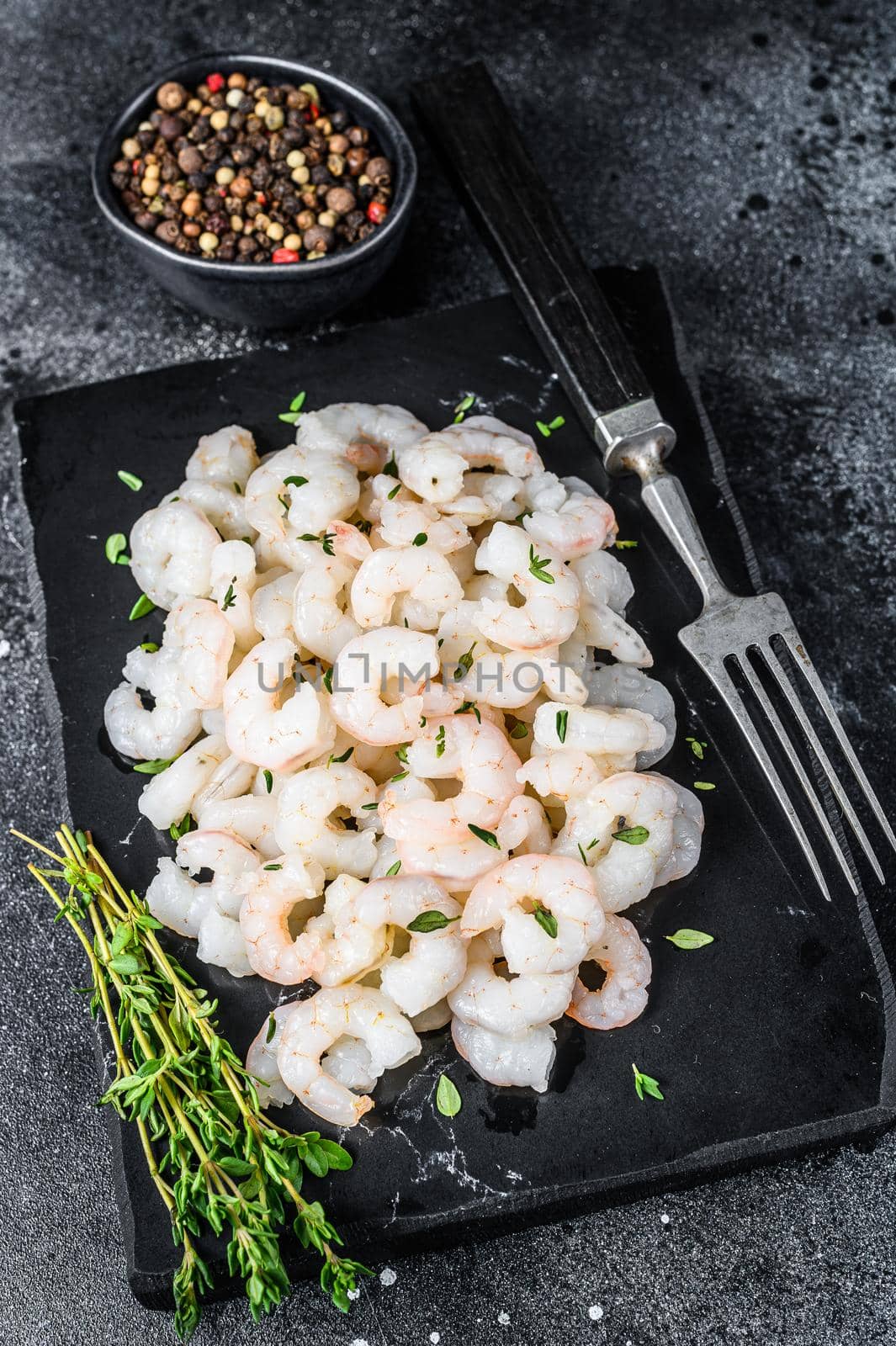 Peeled Shrimps, Prawns on a marble board. Black background. top view by Composter