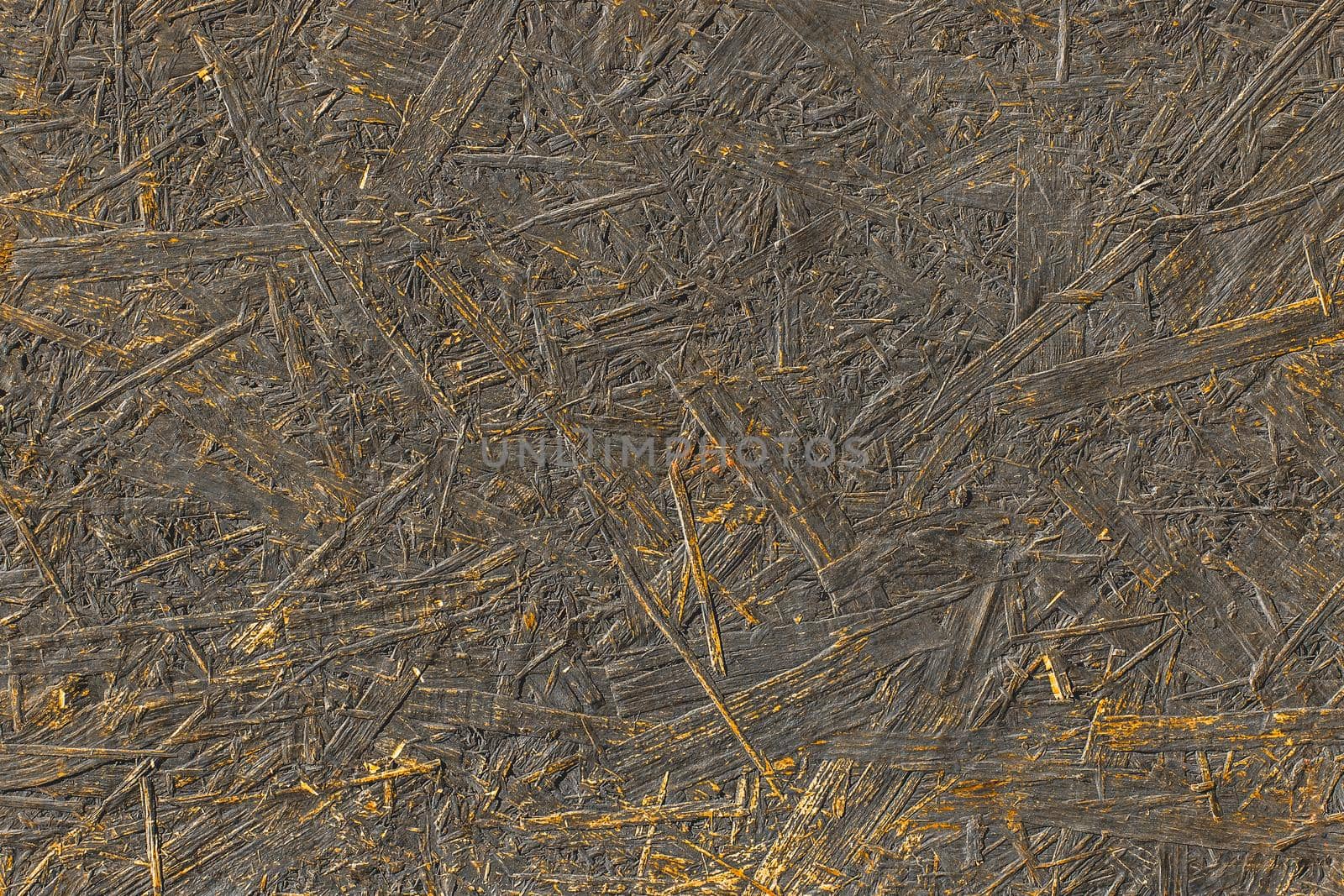 Dark paint on abstract surface of pressed wood chipboard texture background.