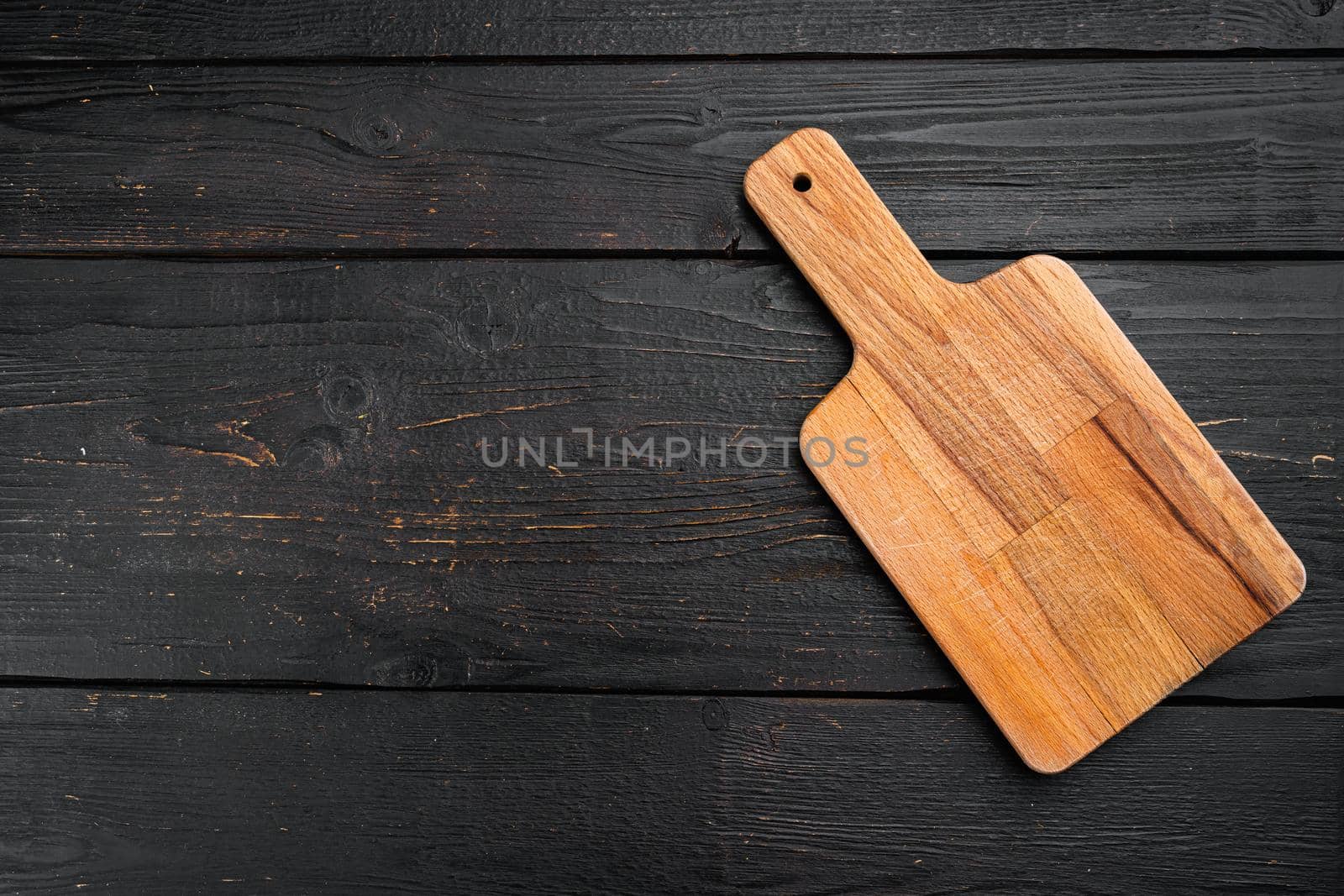 Empty vintage cutting board set, on black wooden table background, top view flat lay , with copy space for text or your product