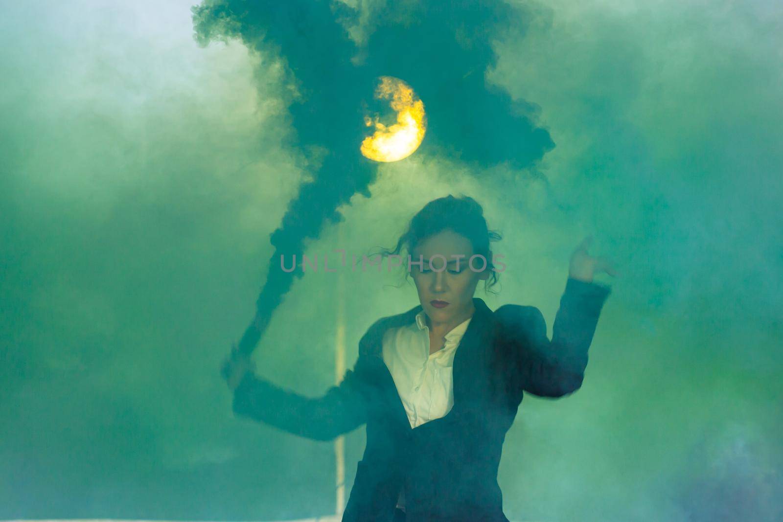 Pasadoble, latin solo dance and contemporary dance - Young beautiful female dancing into smoke cloud.