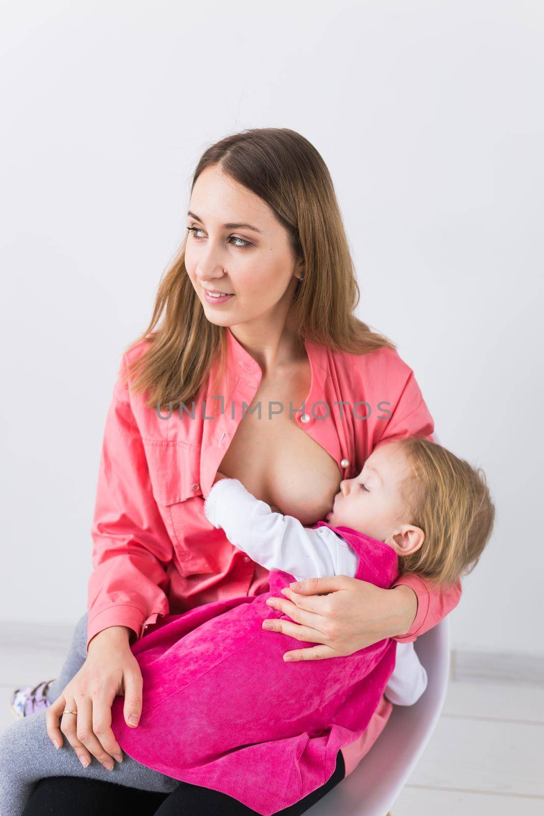 Mother breast feeding and hugging her baby.