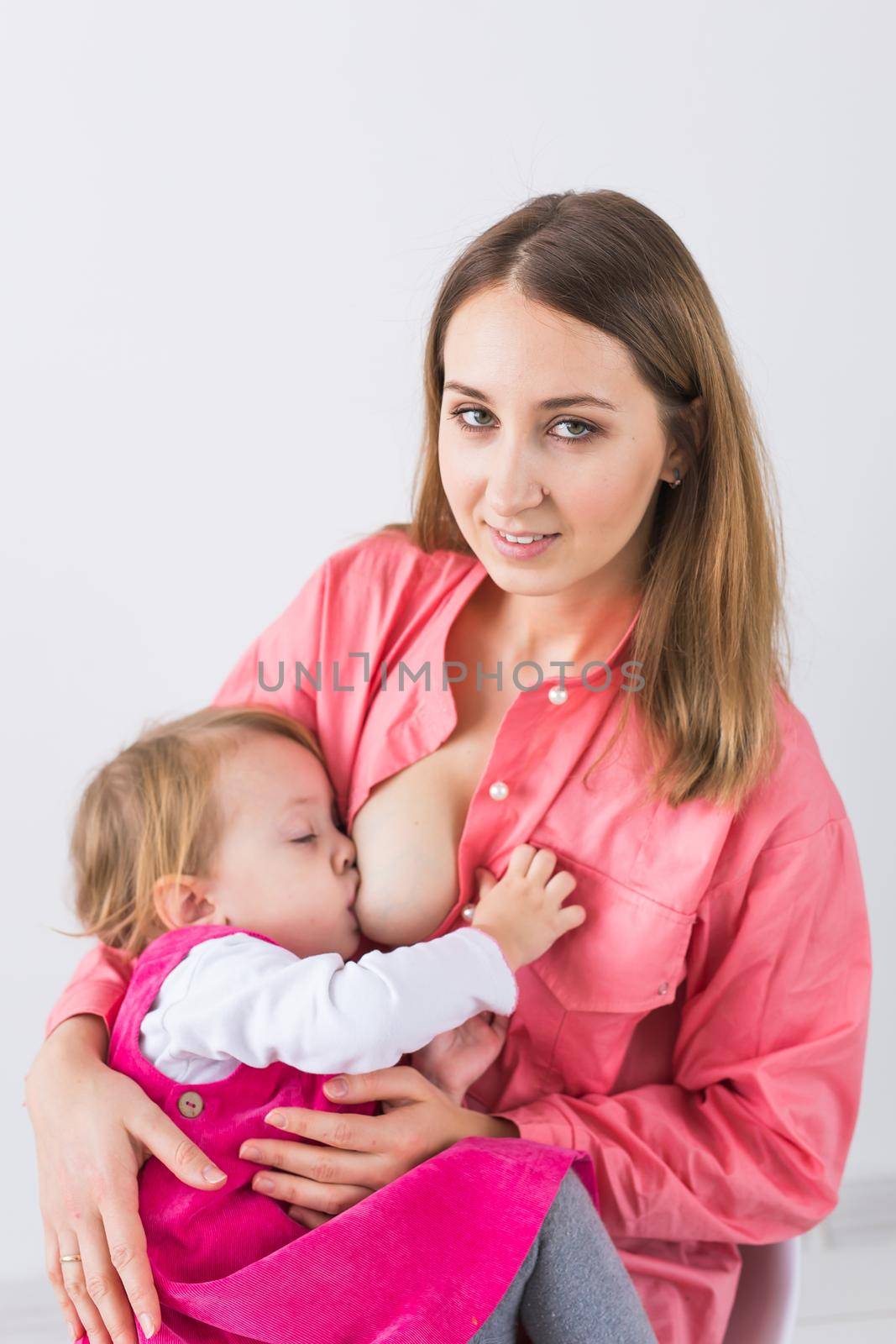 Motherhood concept - Mother and baby lactation on white background