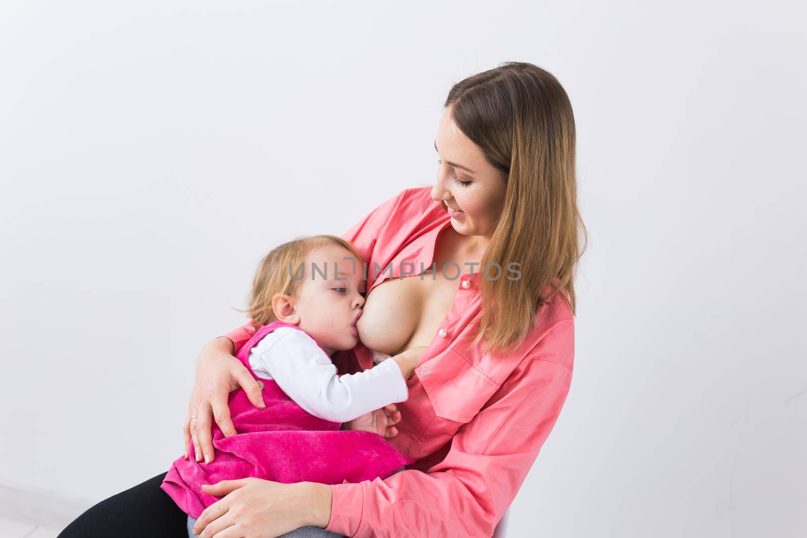 Motherhood and children concept - Mother and baby lactation on white background. by Satura86