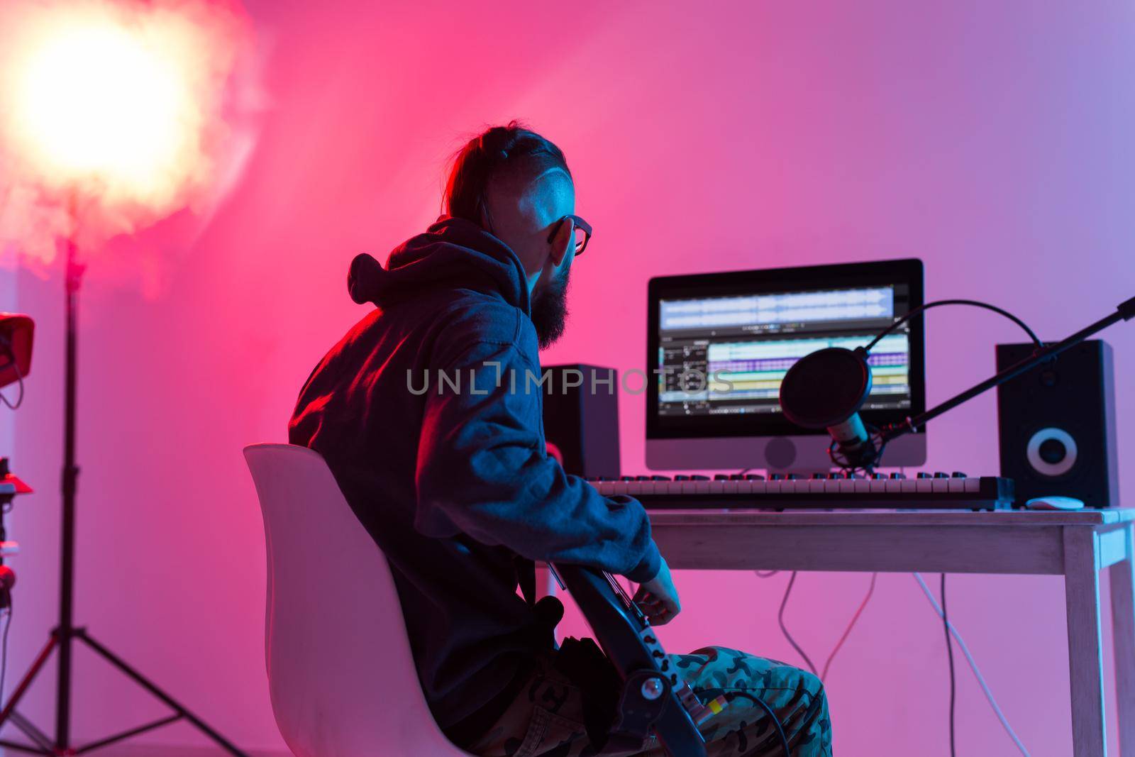Professional musician recording synthesizer in digital studio at home, Music production technology concept