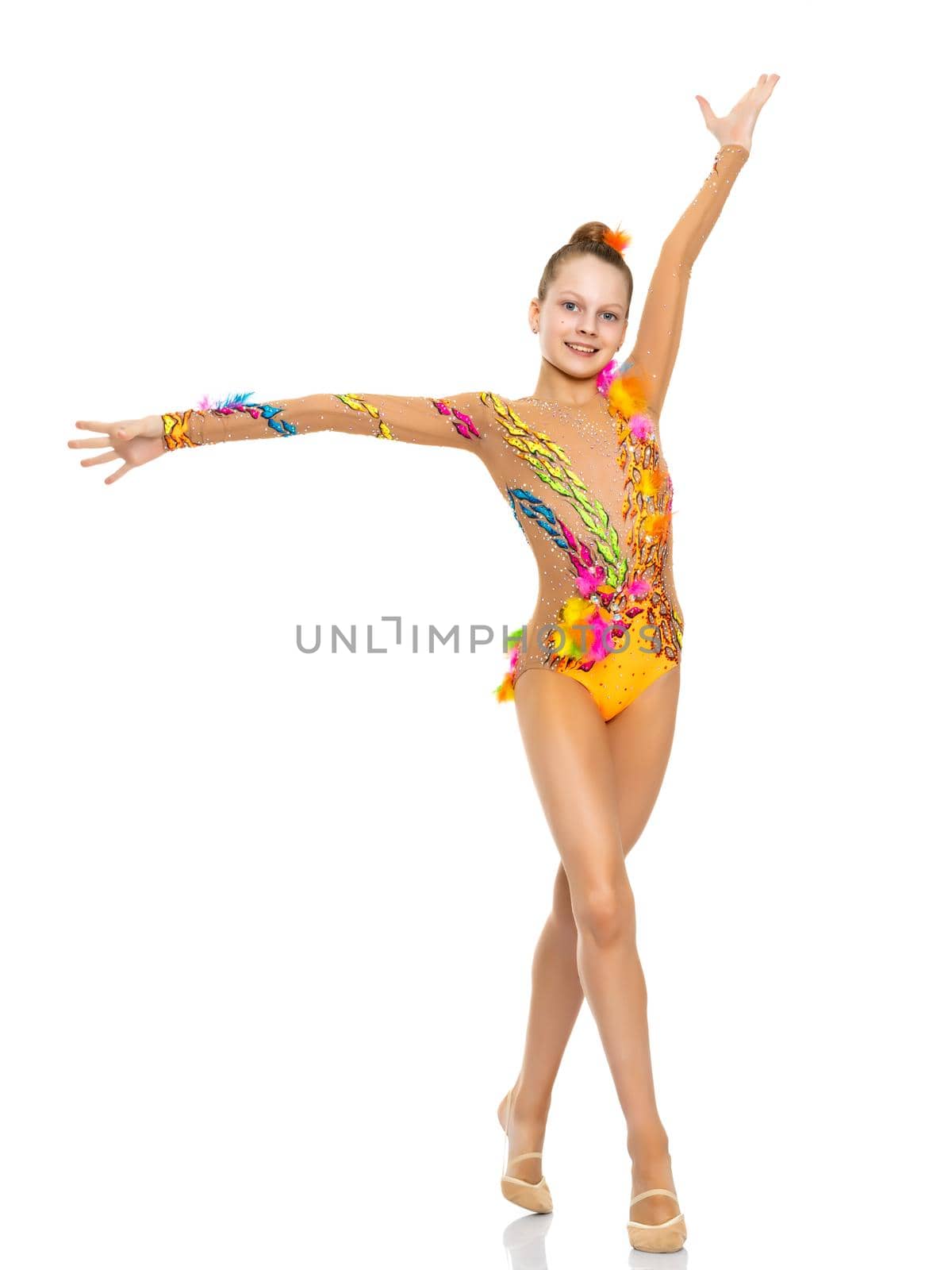 A nice little girl gymnast, in a beautiful gymnastic swimsuit for competitions. In full growth. The concept of advertising sports goods, the physical development of children. Isolated on white background.