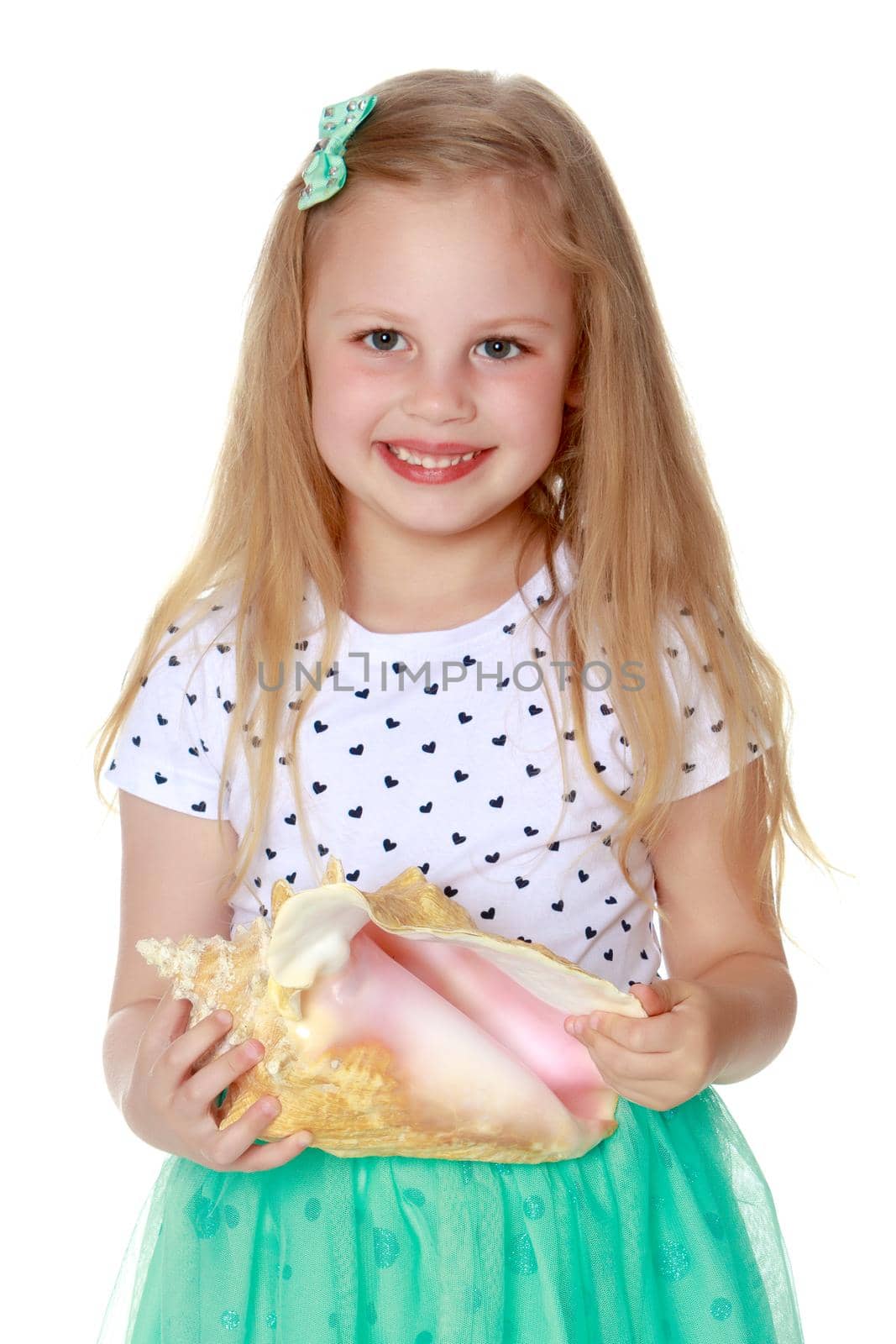 A little girl with a sea shell. The concept of a family vacation at sea, ecology. Isolated on white background.