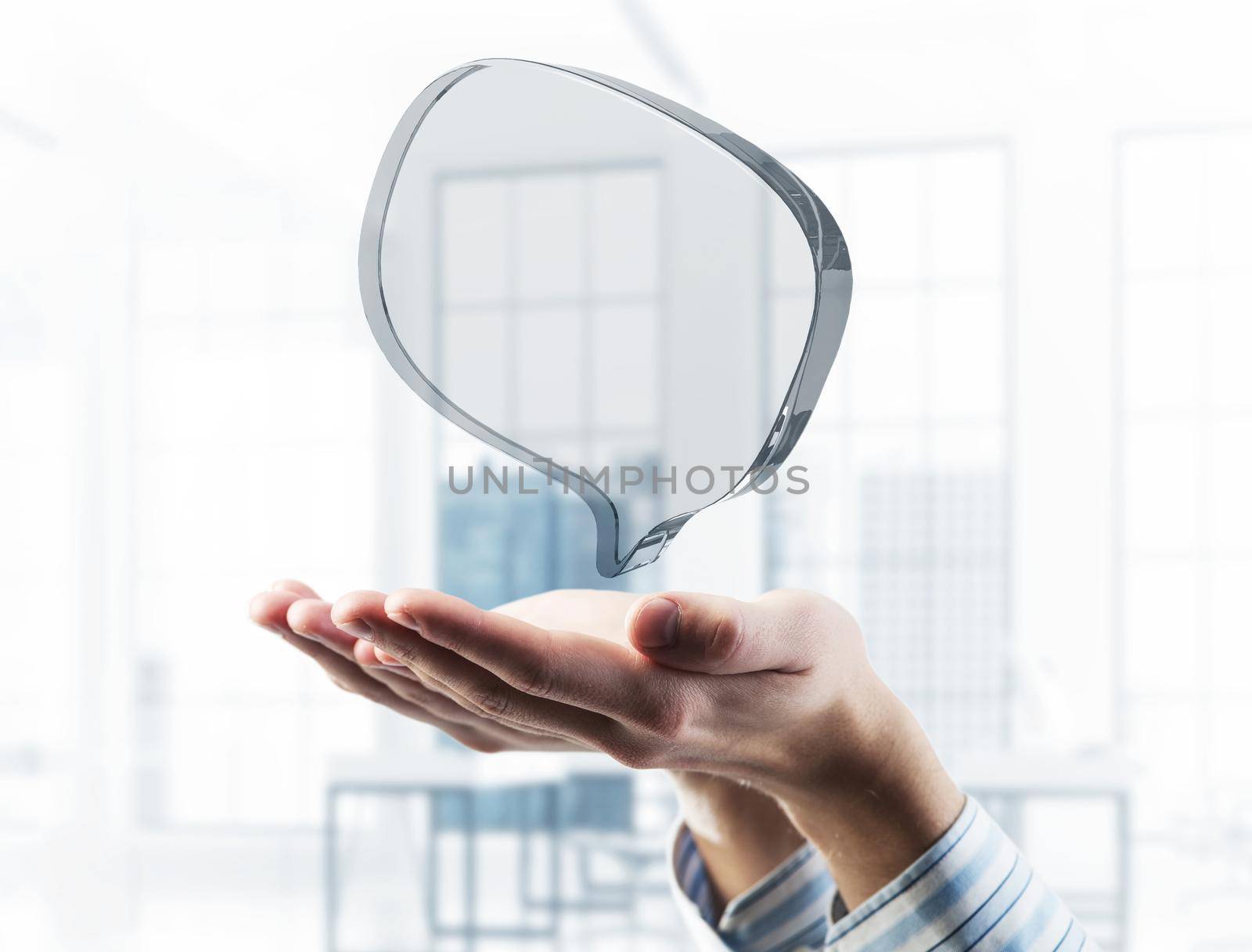 Close of businessman hands showing glass speech bubble as internet concept. Mixed media