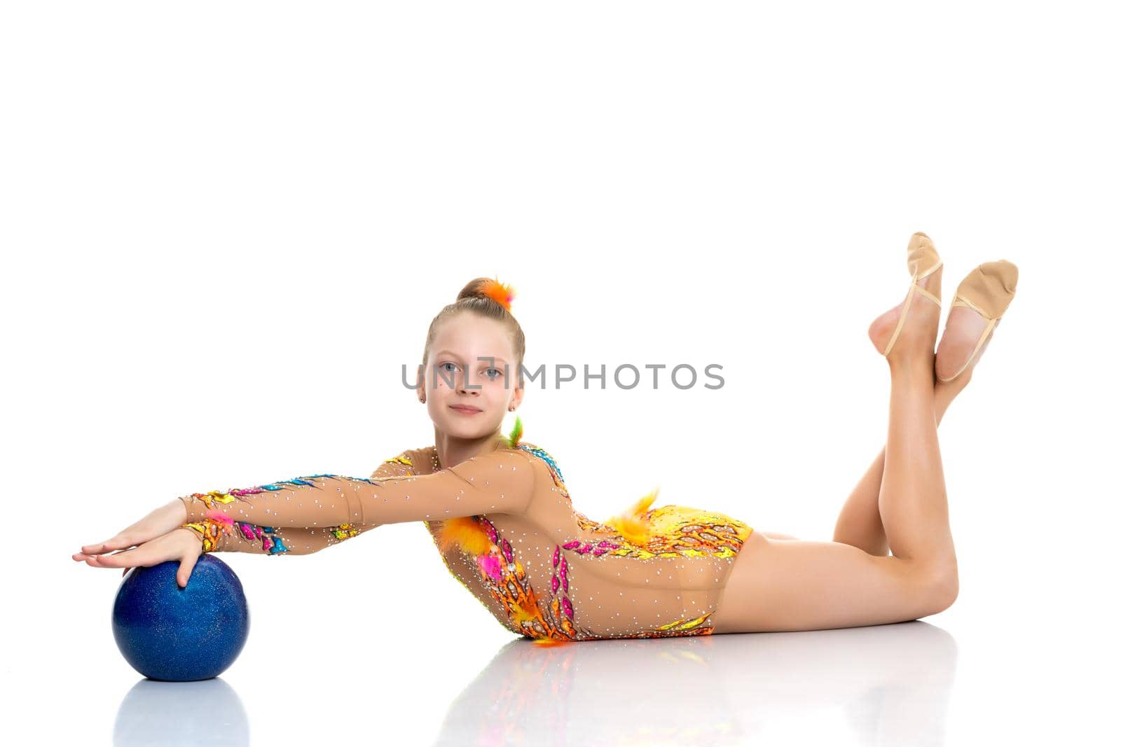 Beautiful little girl gymnast performs exercises with the ball. The concept of children's sports, fitness. Isolated on white background.