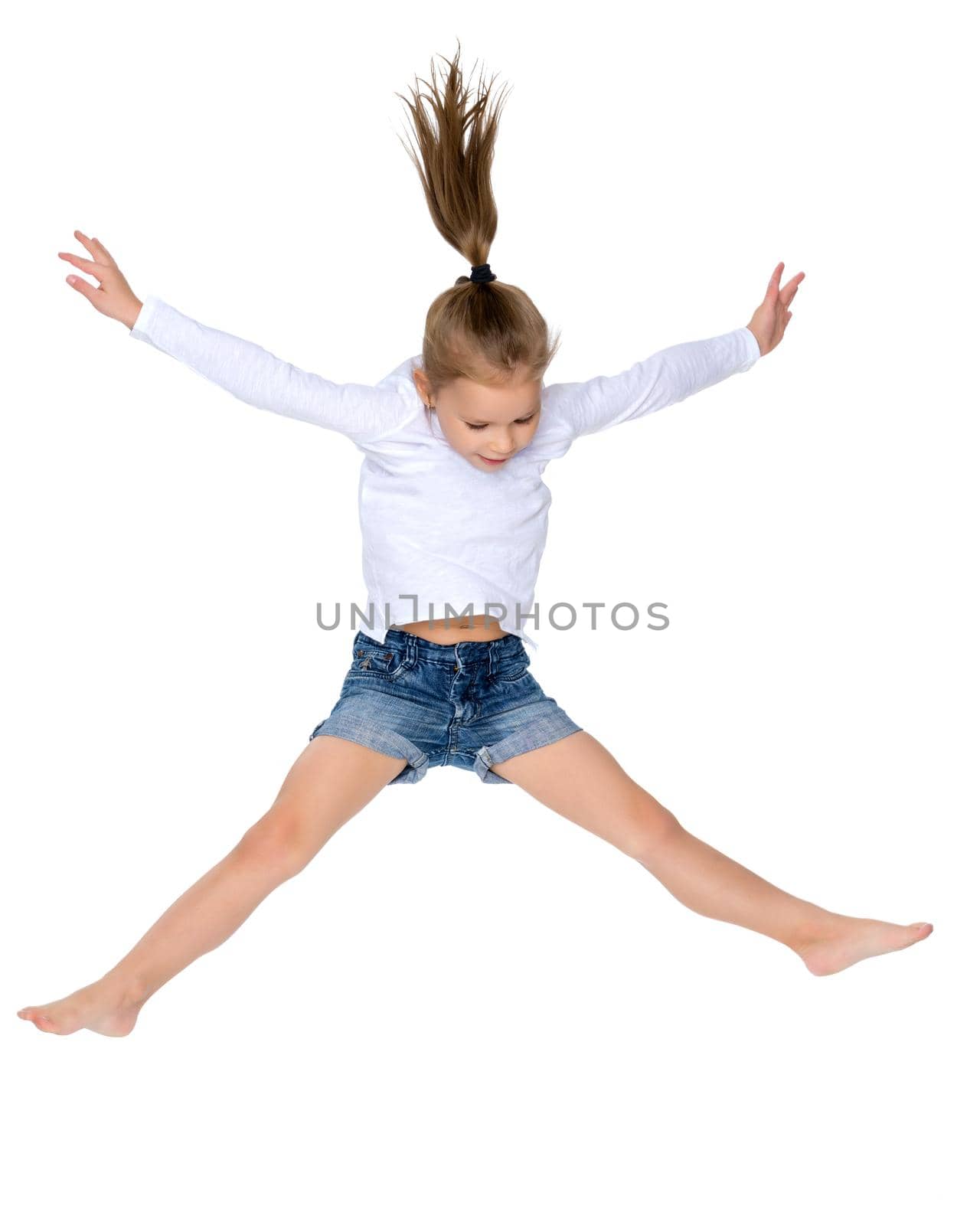 A little girl is jumping and waving her hands. The concept of a happy childhood, outdoor recreation. Isolated on white background.