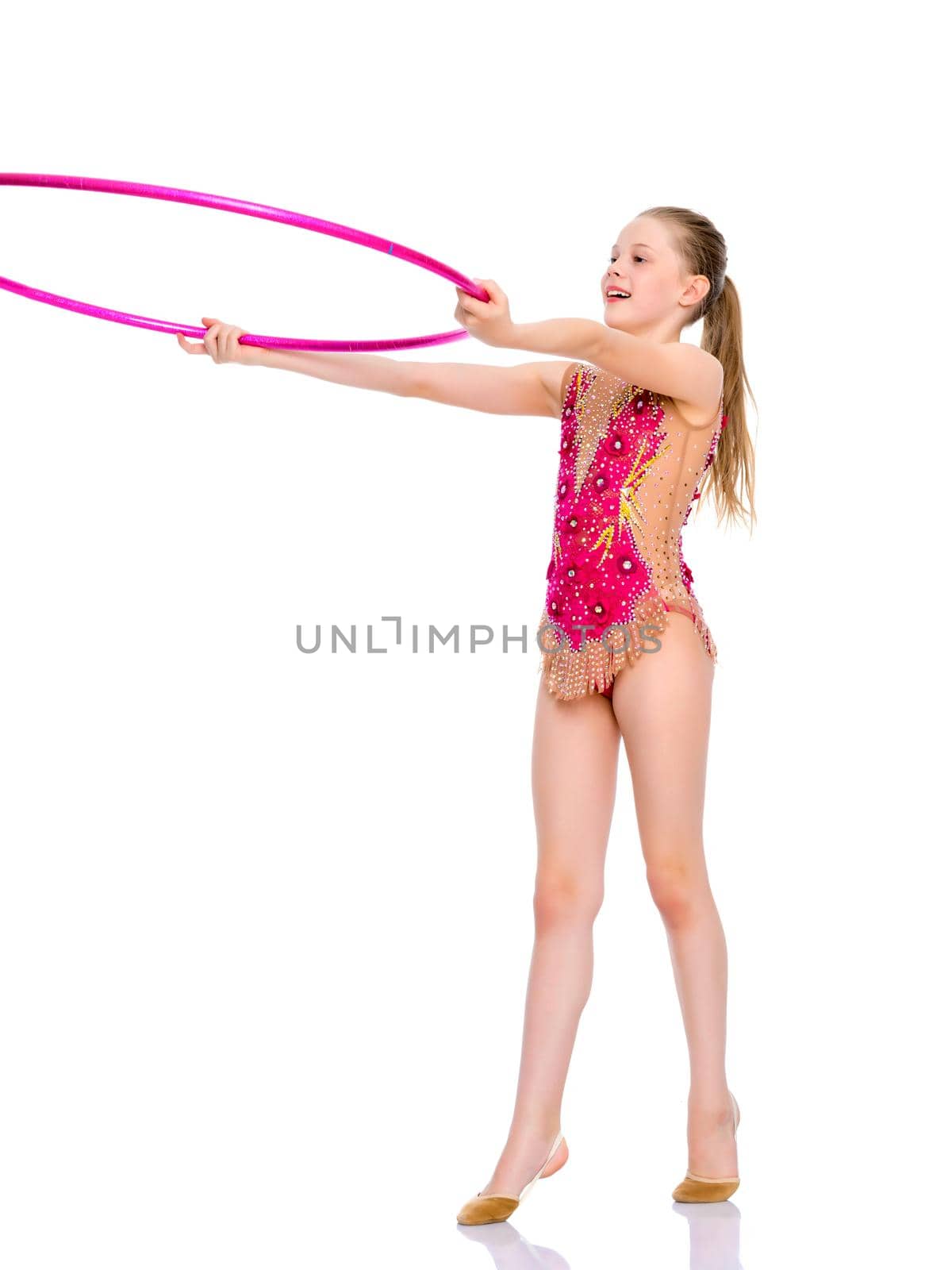 A girl gymnast performs an exercise with a hoop. The concept of gymnastics and fitness. Isolated on white background.