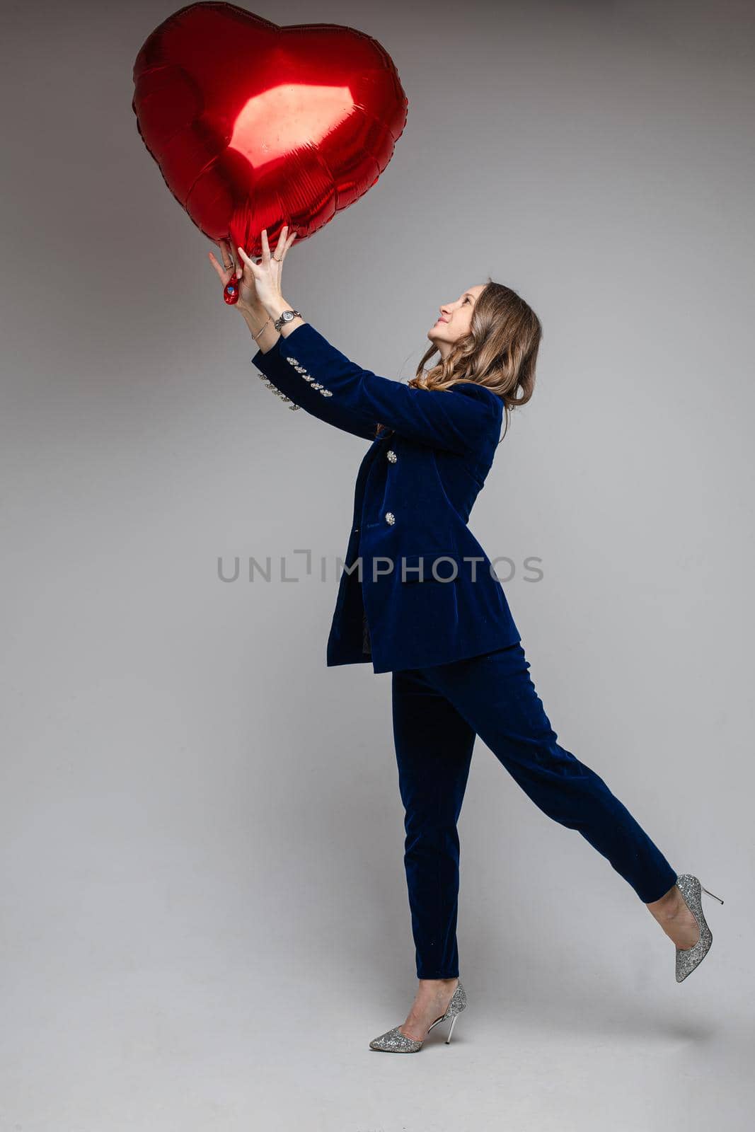 Woman in velvet suit with heart air balloon. by StudioLucky