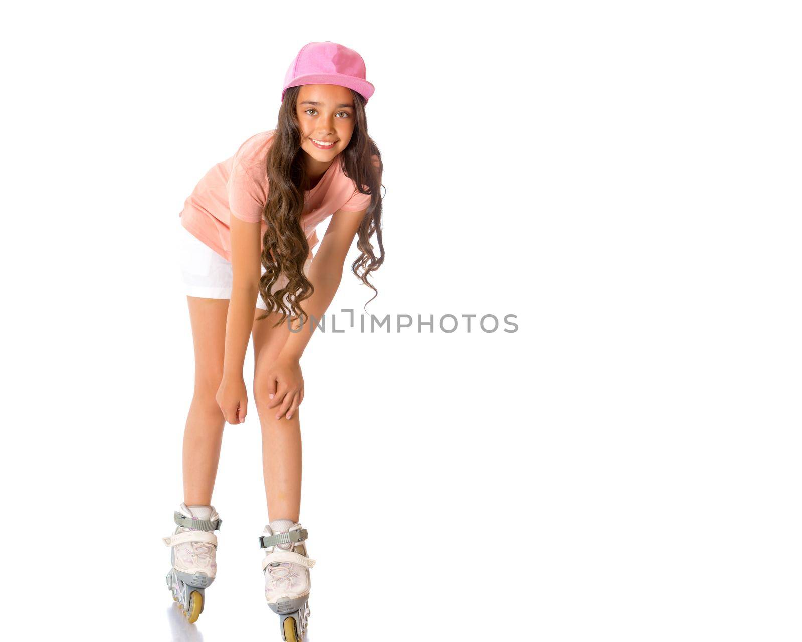 Beautiful Asian girl teenager with long black hair, in a T-shirt and shorts, skates inline skates. The concept of advertising sports goods, a healthy lifestyle. Isolated on white background.