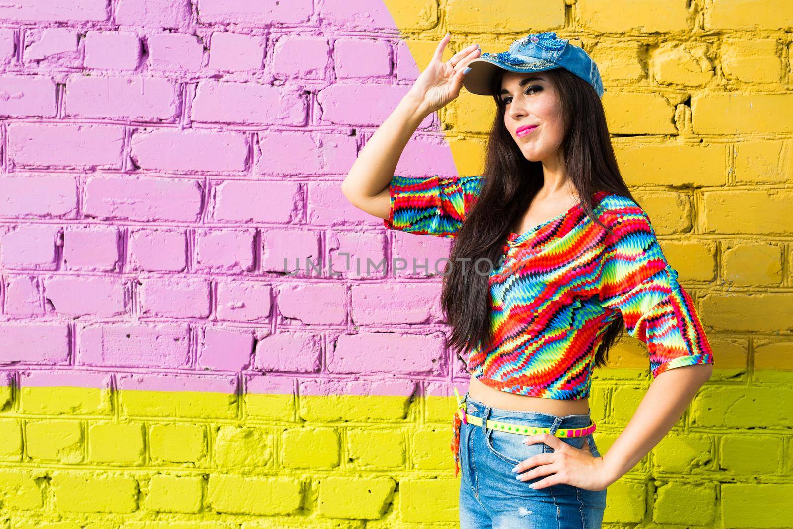 Street dance, freestyle and jazz funk concept - Beautiful girl dancing hip-hop over brick wall.