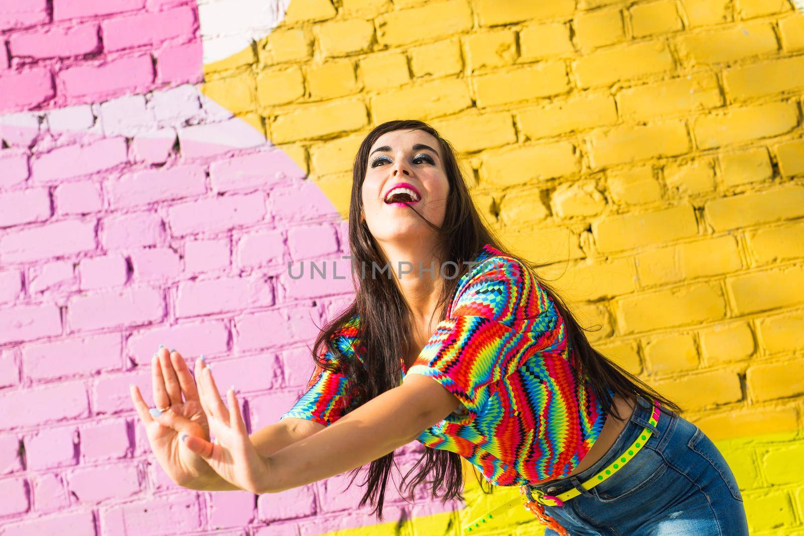 Street shaabi dance and urban dancer concept - Cheerful belly dancer dancing with arabic music on the street.