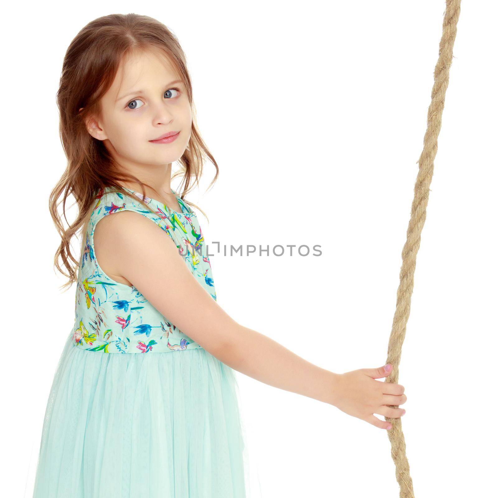 Fashionable little girl in a dress. Beauty and style in children's clothes. Isolated over white background