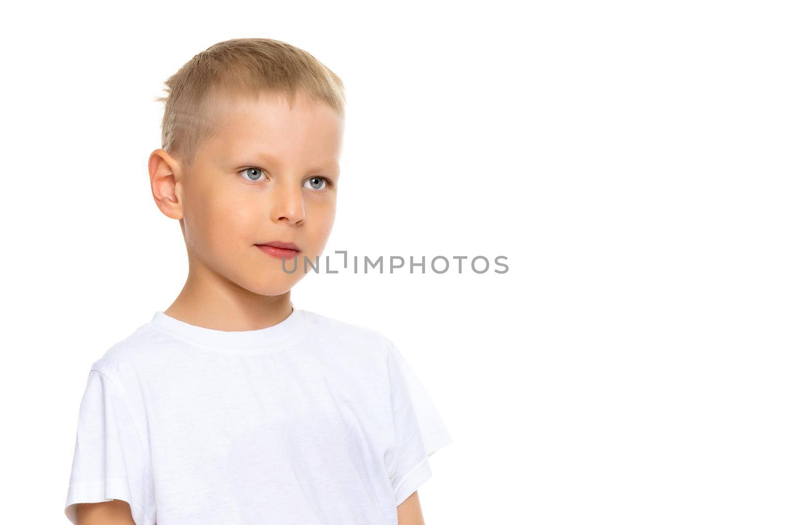 A cute little boy in a white T-shirt. The concept of promotional goods, inscriptions and drawings on clothes. Isolated on white background.