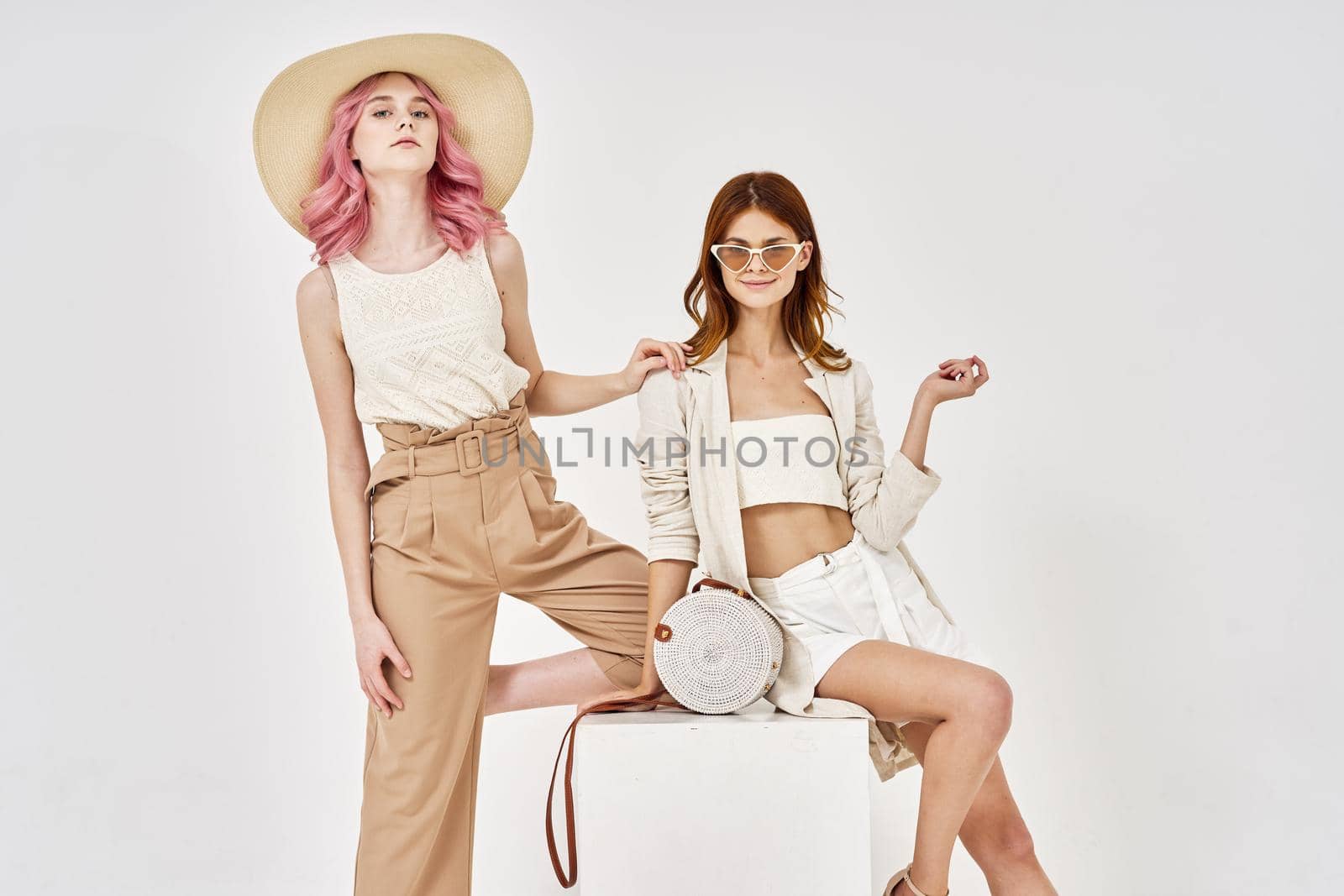 two women fashionable clothes posing accessories summer style by Vichizh