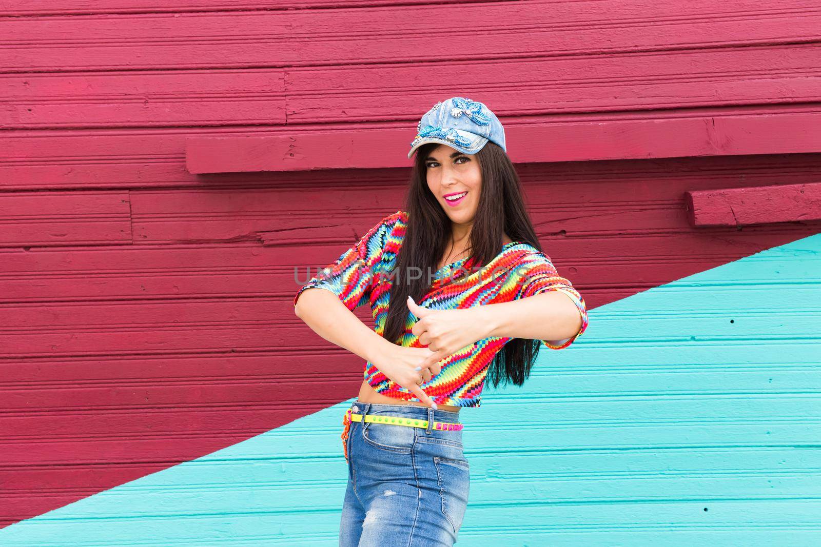 Street dance, freestyle and jazz funk concept - Beautiful girl dancing hip-hop over red and blue brick wall.
