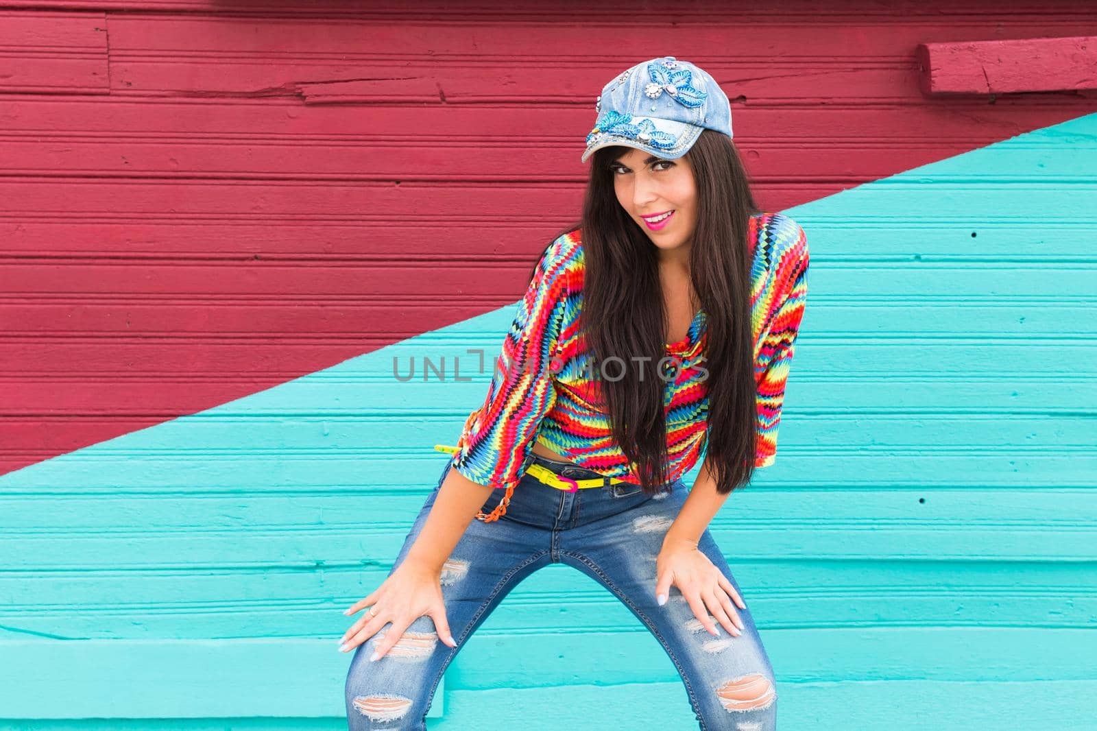 Street dance, freestyle and jazz funk concept - Beautiful girl dancing hip-hop over red and blue brick wall.