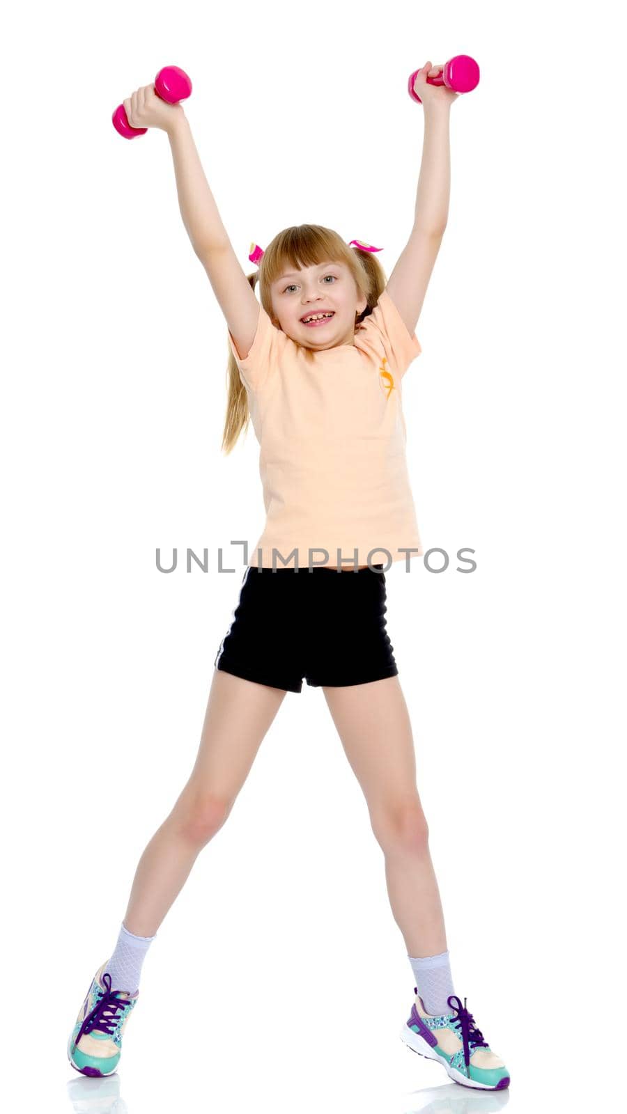 Little girl doing exercises with dumbbells. by kolesnikov_studio
