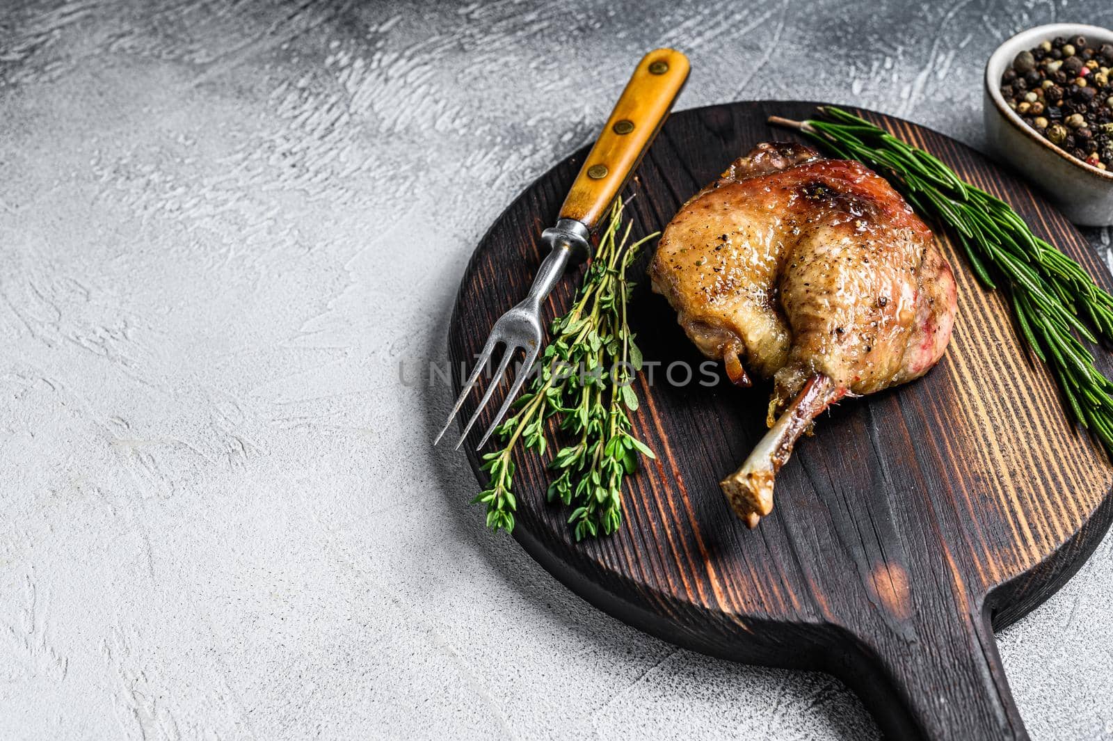 Fried duck confit leg baked poultry meat. White background. top view. Copy space.