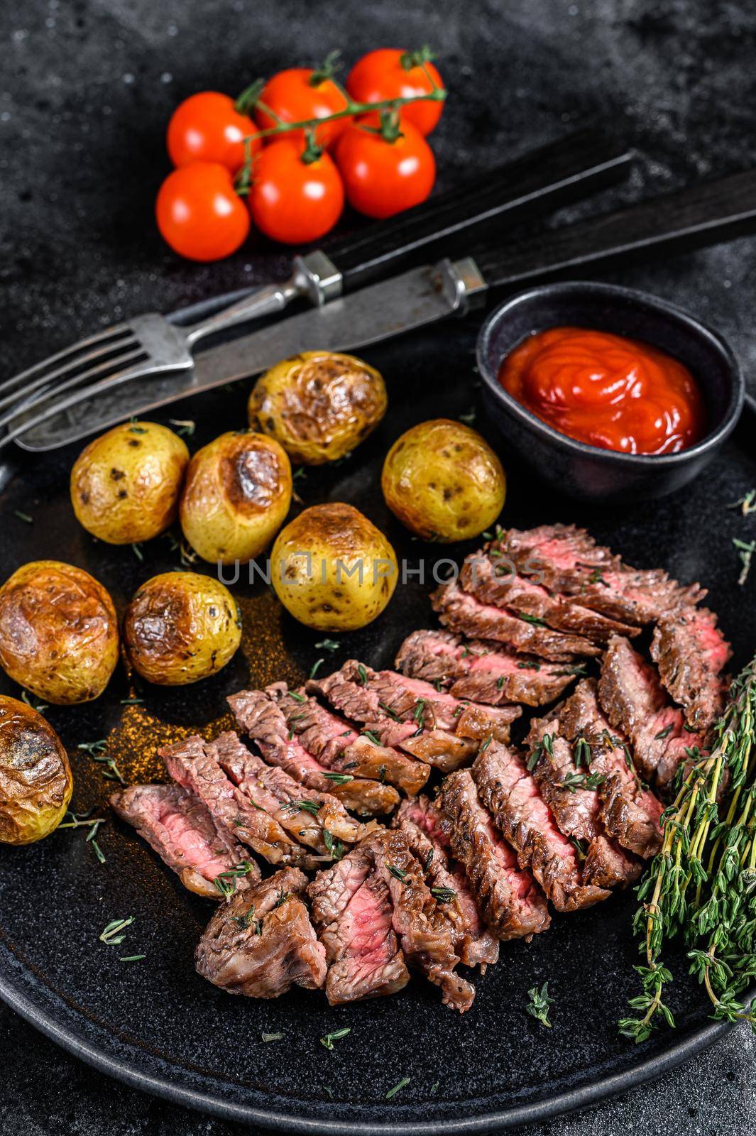 Grilled marble meat beef Steak with fried potato. Black background. Top view.