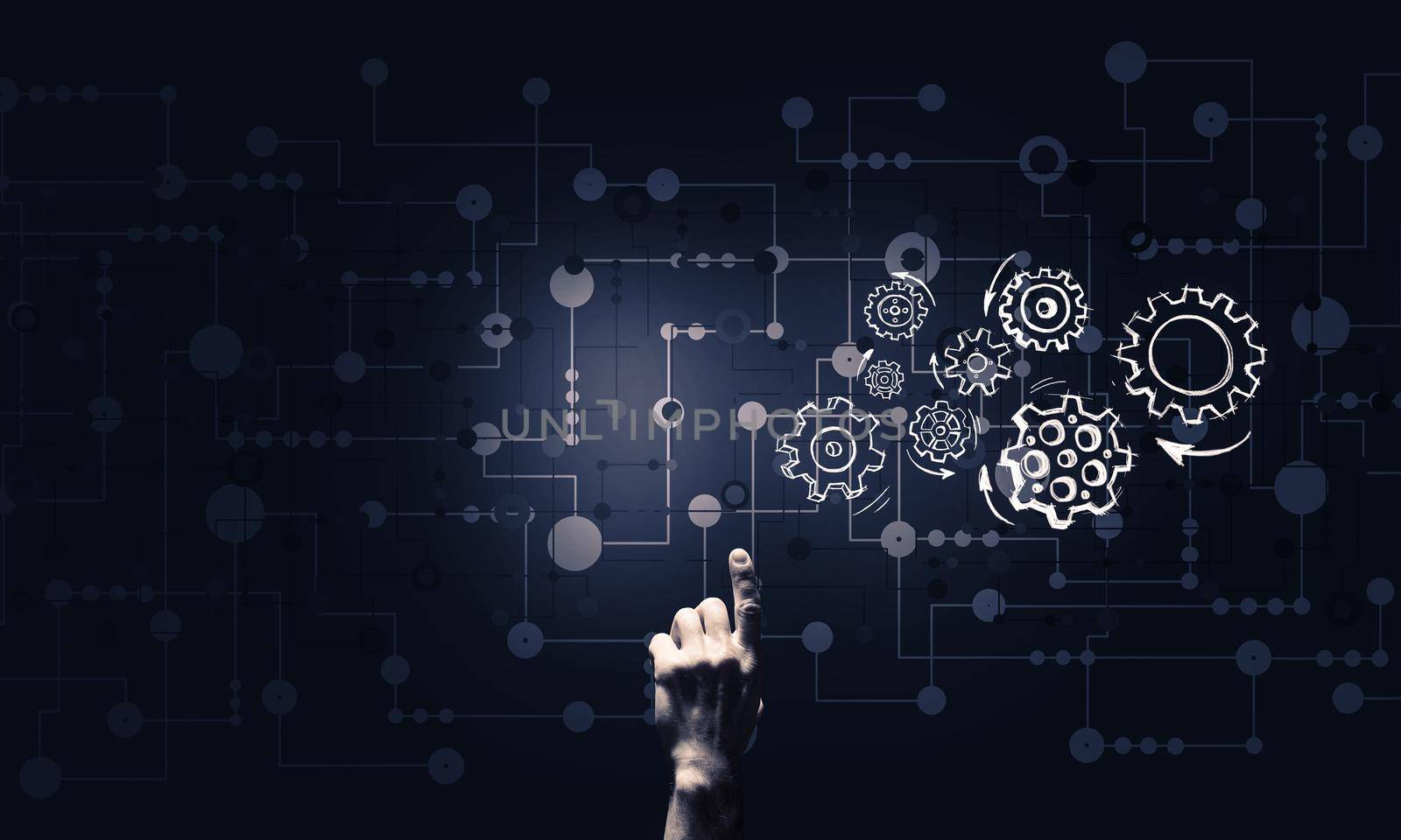 Close of businessman hand pointing with finger at gear mechanism