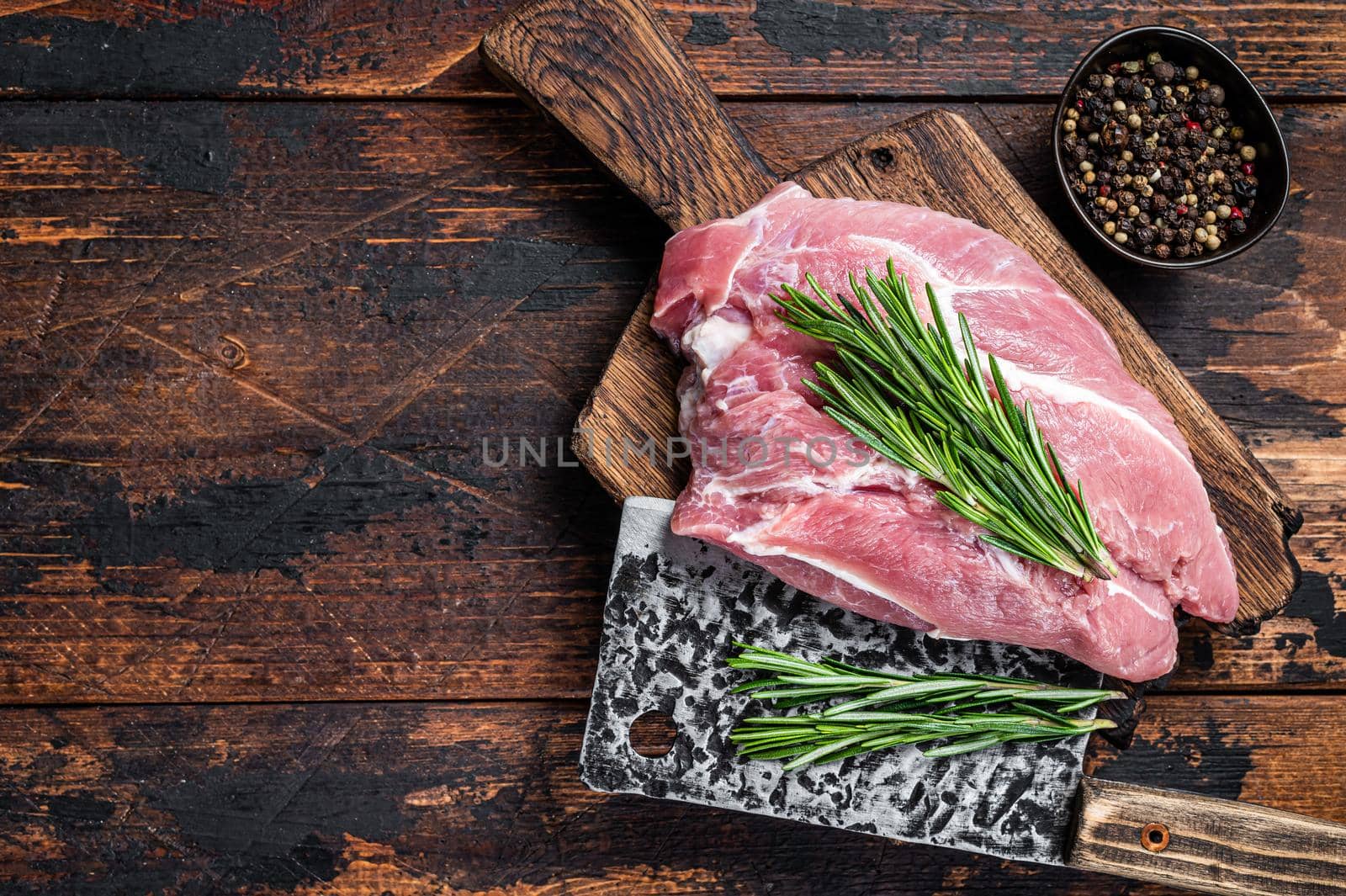 Fresh Raw pork shoulder meat cut with ingredients and spices on kitchen background. Dark wooden background. Top view. Copy space.