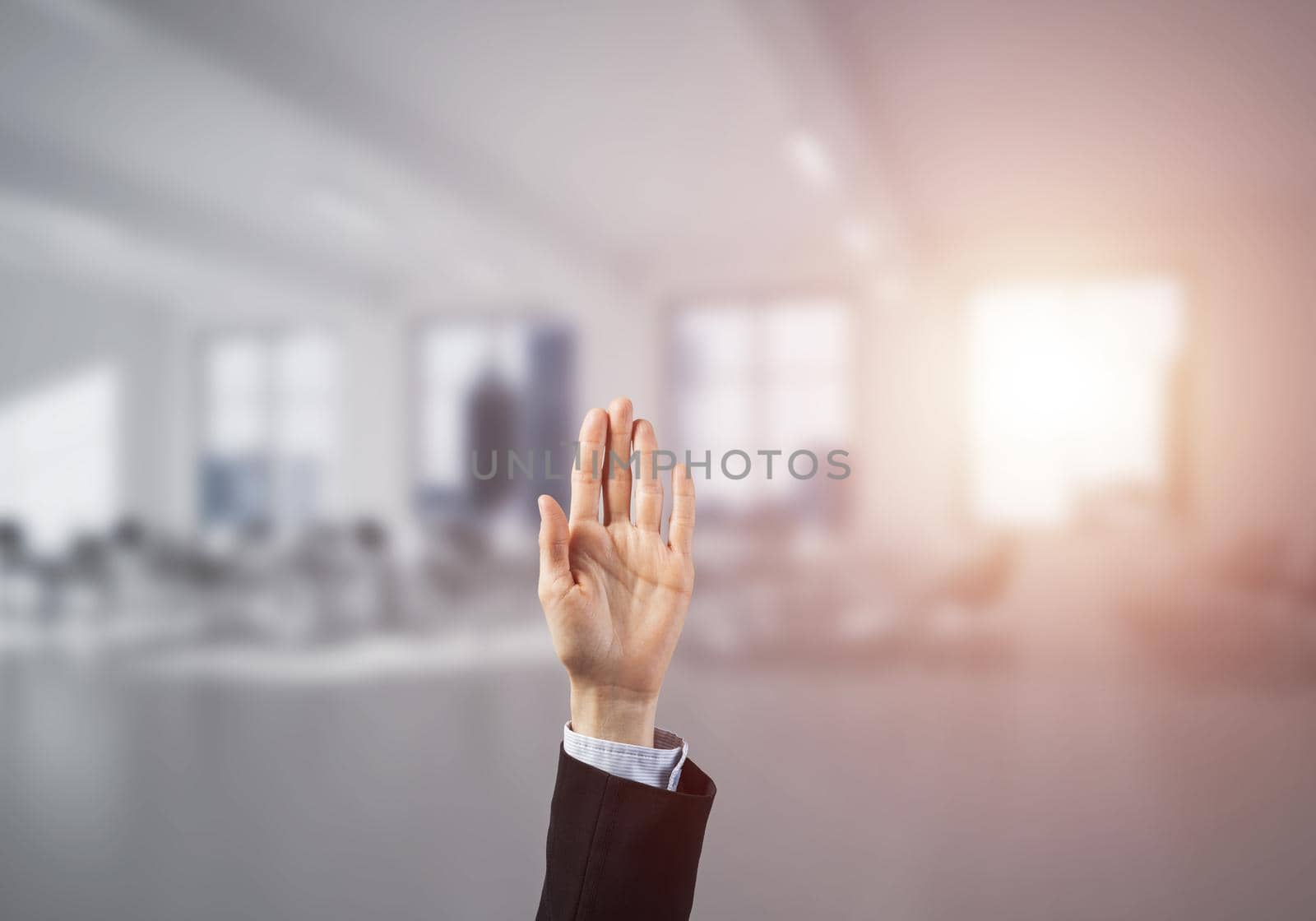Close of businesswoman hand touching screen with palm and office at background