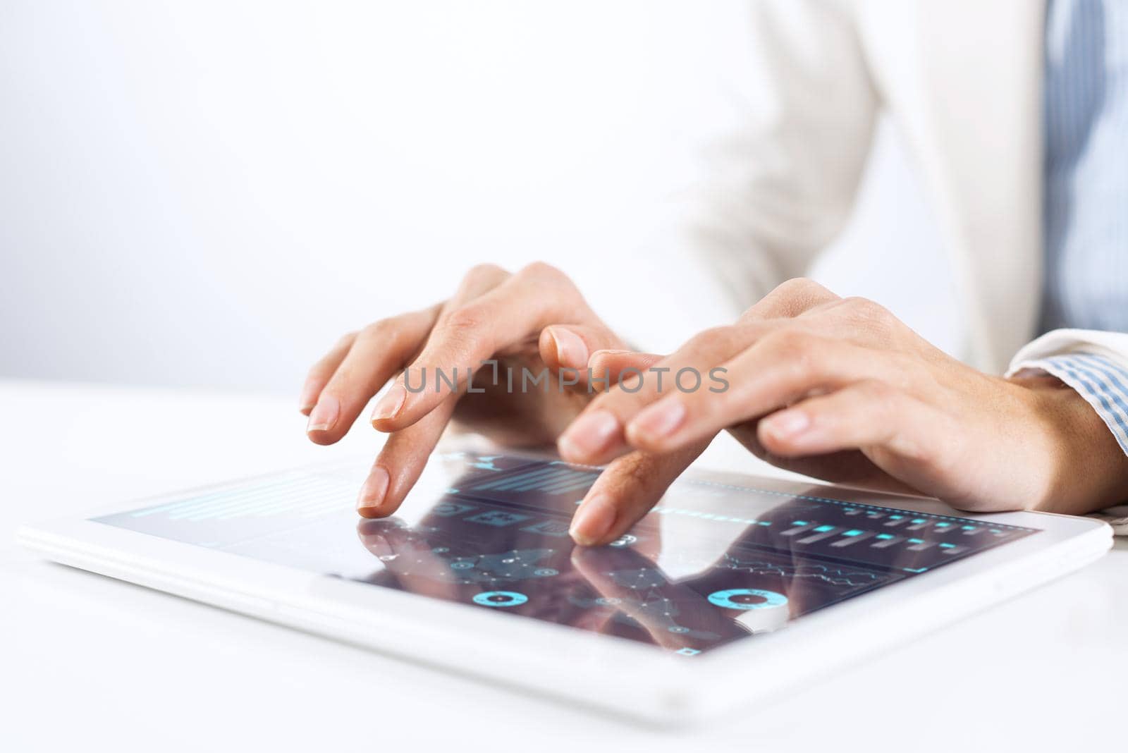 Broker in white suit using tablet computer for financial data analysis. Close-up of male hands touching screen of tablet device. Online stock trading application. Mobile smart device in business.