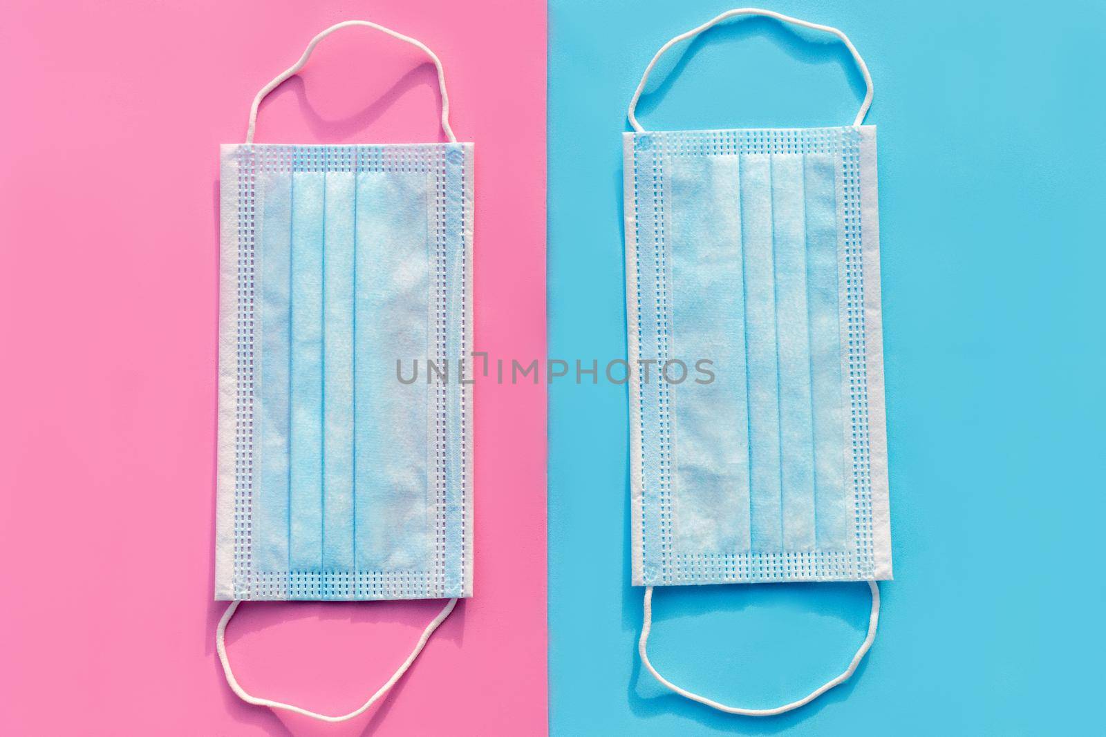 Ear loop face mask 2 layers, protective masks on a blue and pink background. dust protection respirator and respiratory medical respiratory mask by Matiunina