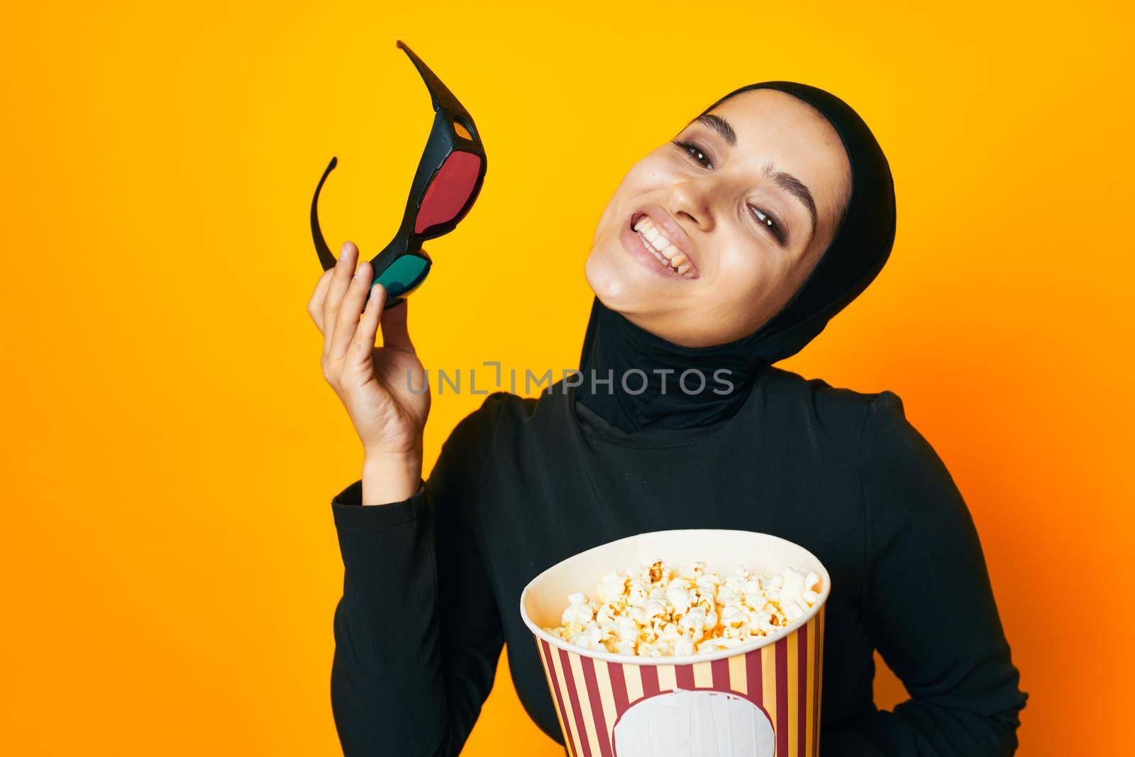 arab woman watching movies 3D glasses fun studio lifestyle. High quality photo