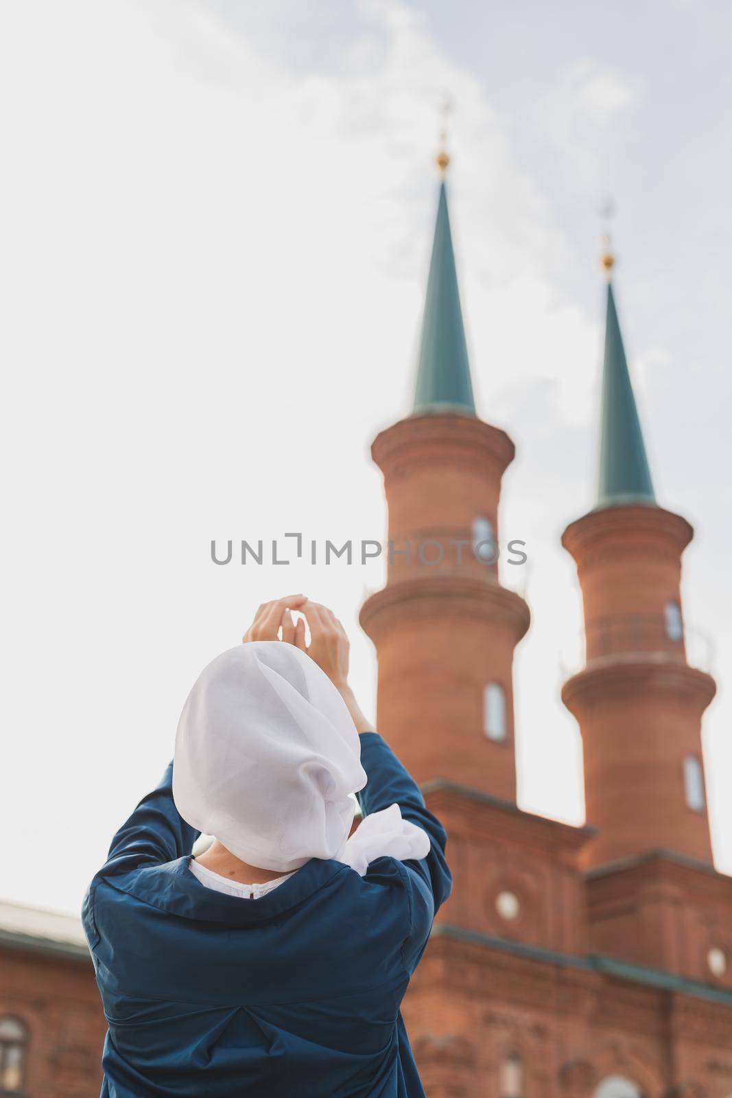 Young Muslim woman prayer wear hijab fasting pray to allah on mosque background