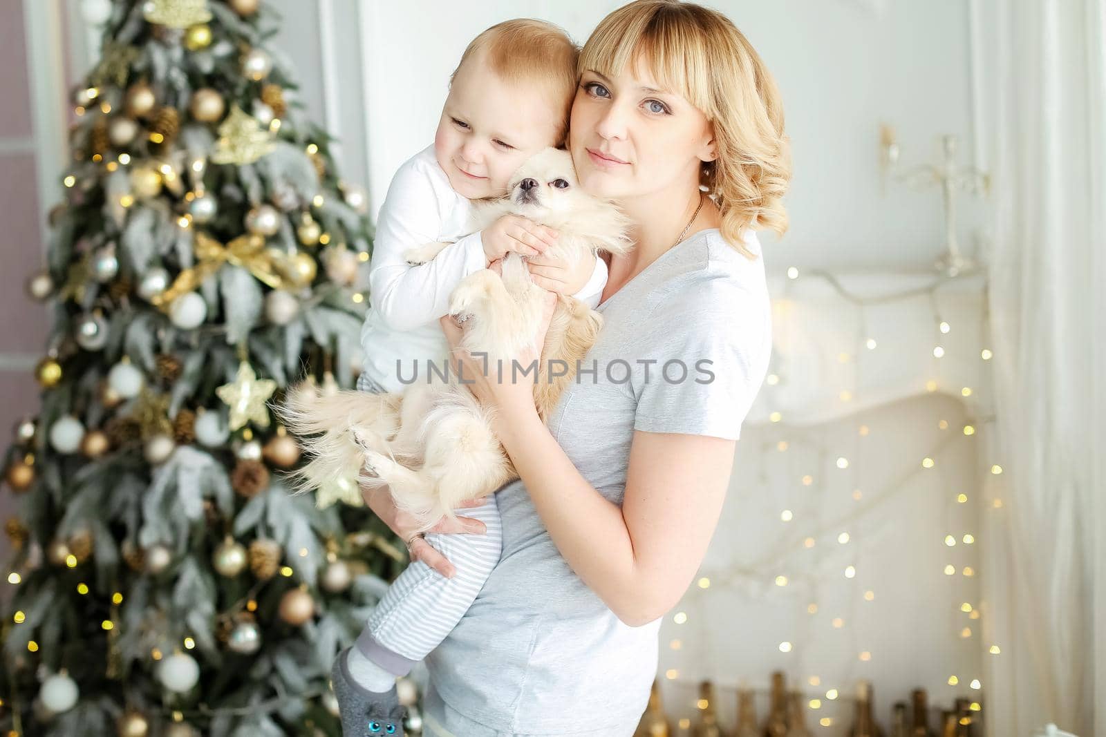 Family photo of mother and daughter at home in bright colors on Christmas day.