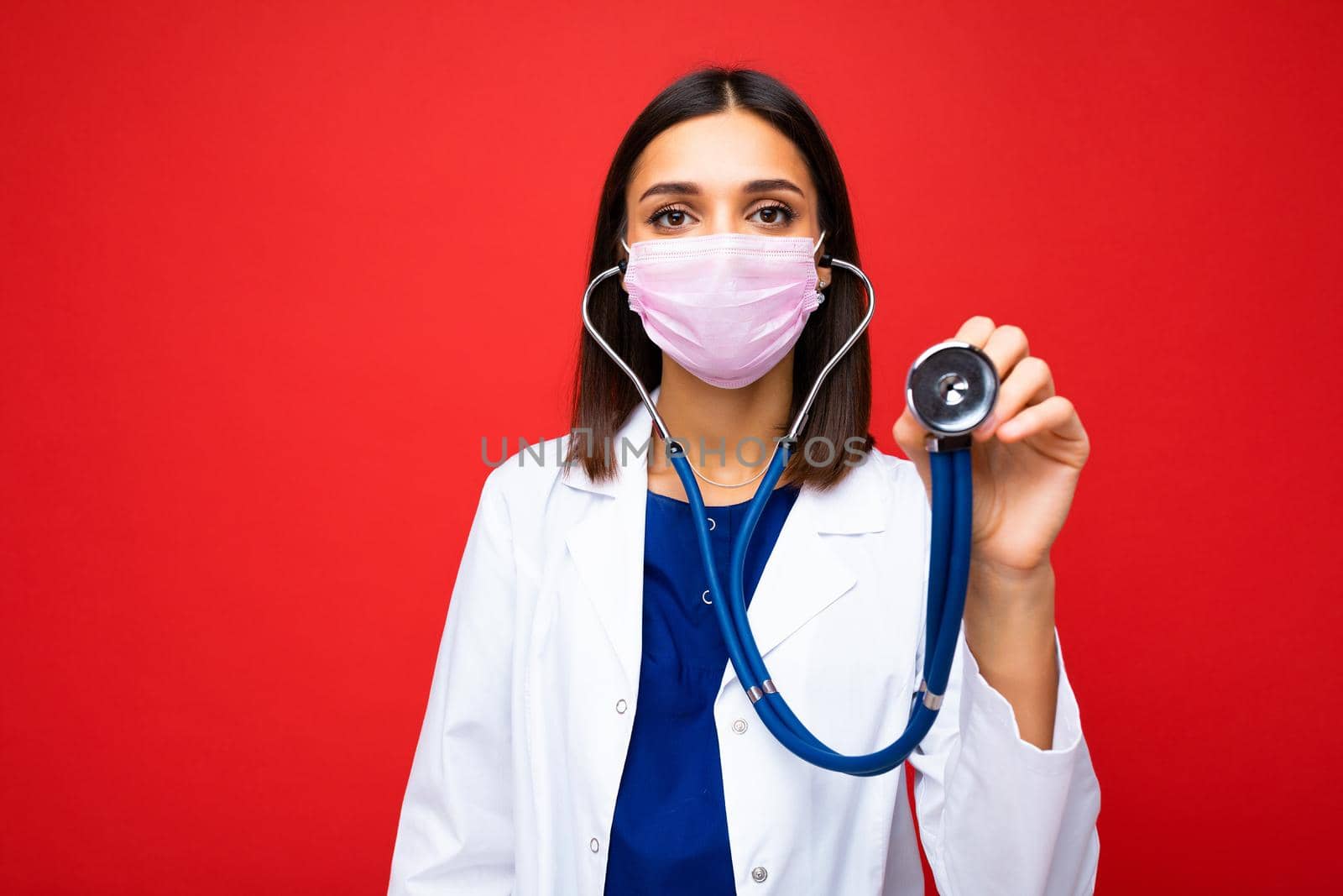 Covid19, coronavirus, healthcare and doctors concept. Photo of professional confident young european doctor in medical mask and white coat, stethoscope over neck, ready help patient, fight disease.