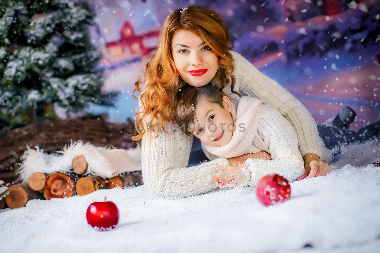 Mother with a child on the background of New Year's lectures look directly into the camera by ElenaBatkova