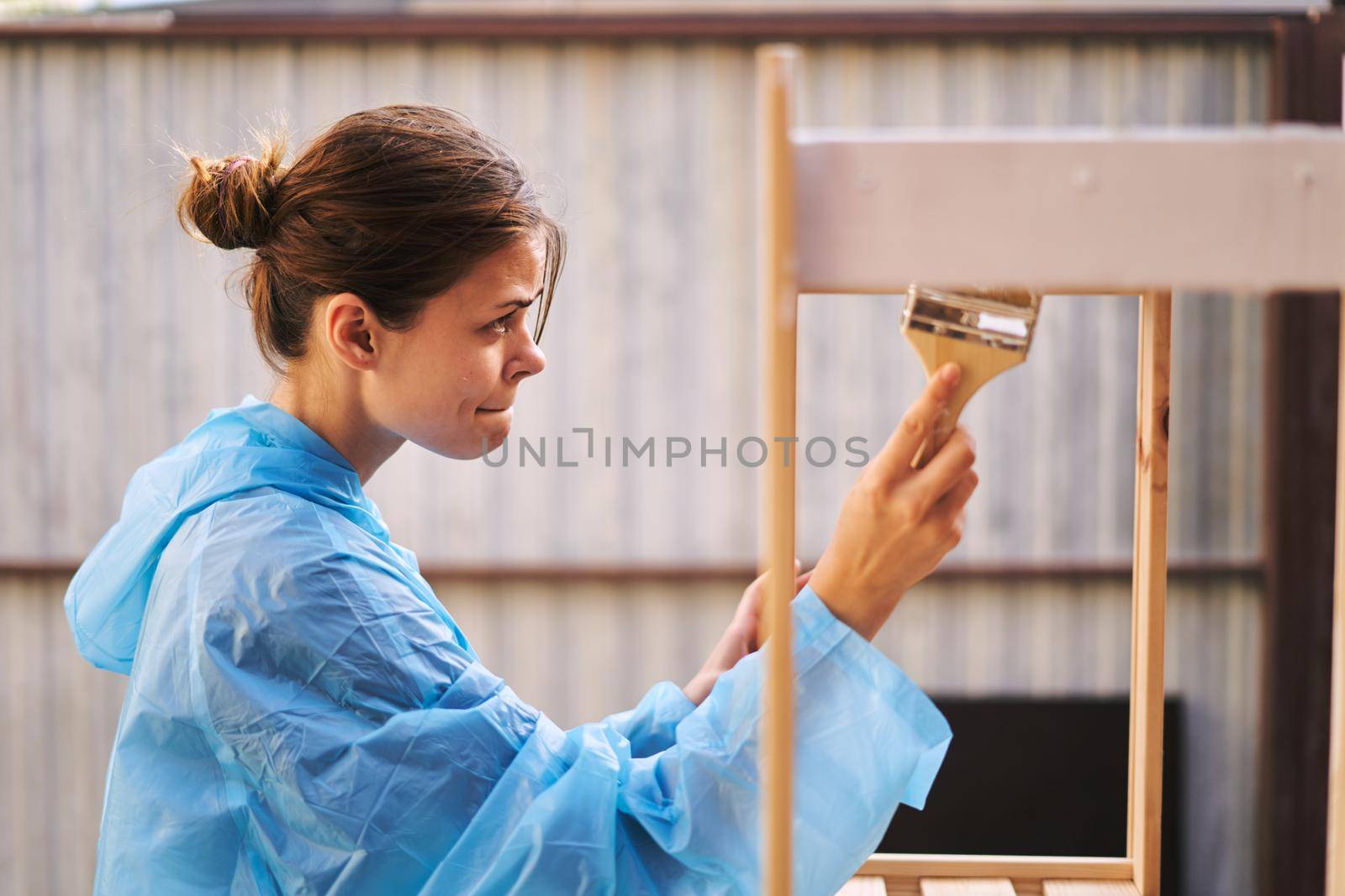 woman painter protective clothing wooden fittings renovation. High quality photo